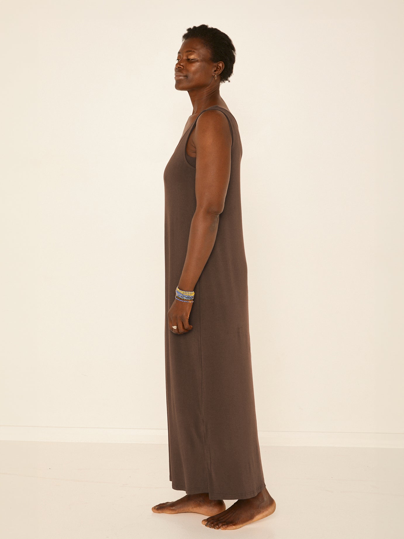Model wearing a reversible cocoa brown maxi length dress with scoop and boat necklines, women's bamboo clothing