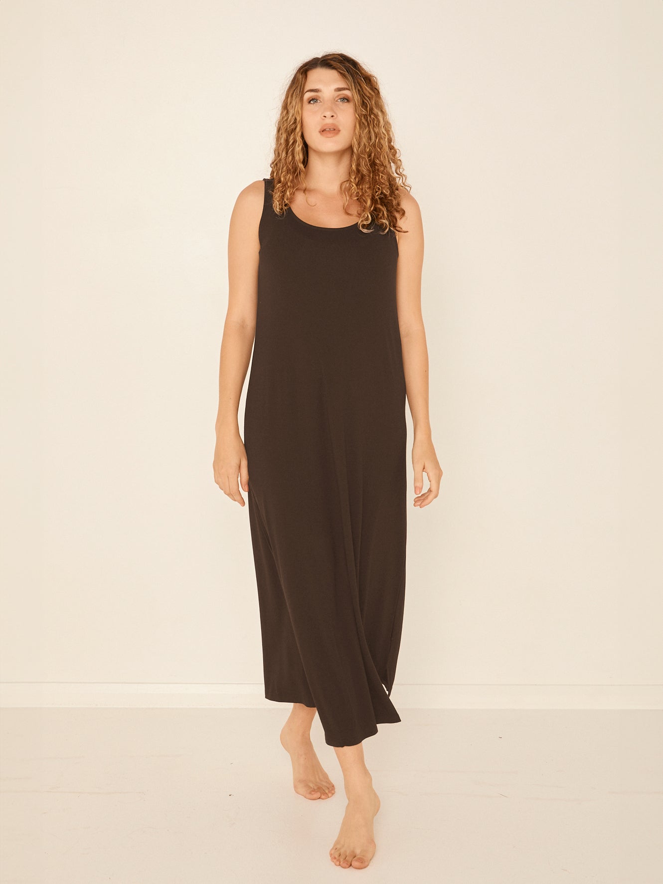 Model wearing a reversible cocoa brown maxi length dress with scoop and boat necklines, women's bamboo clothing