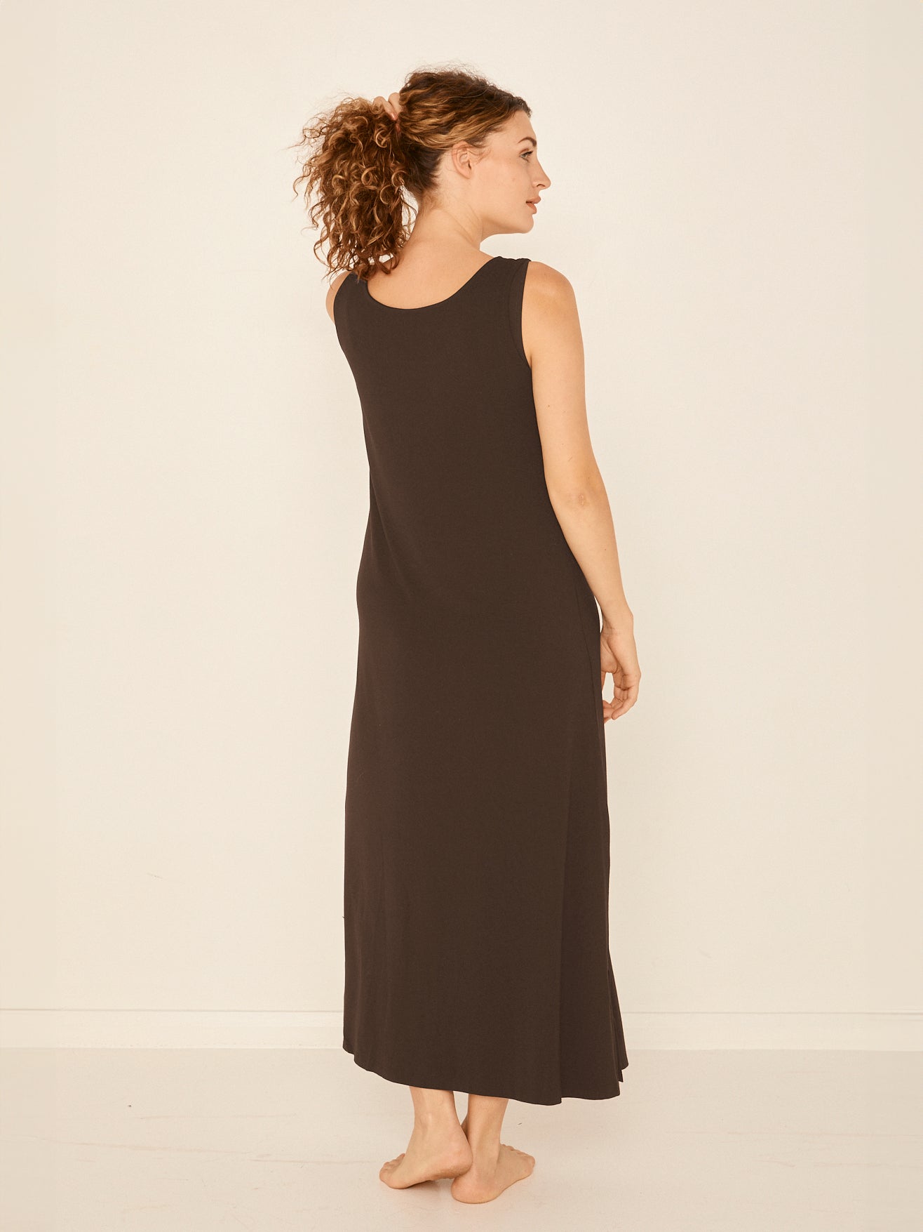 Model wearing a reversible cocoa brown maxi length dress with scoop and boat necklines, women's bamboo clothing