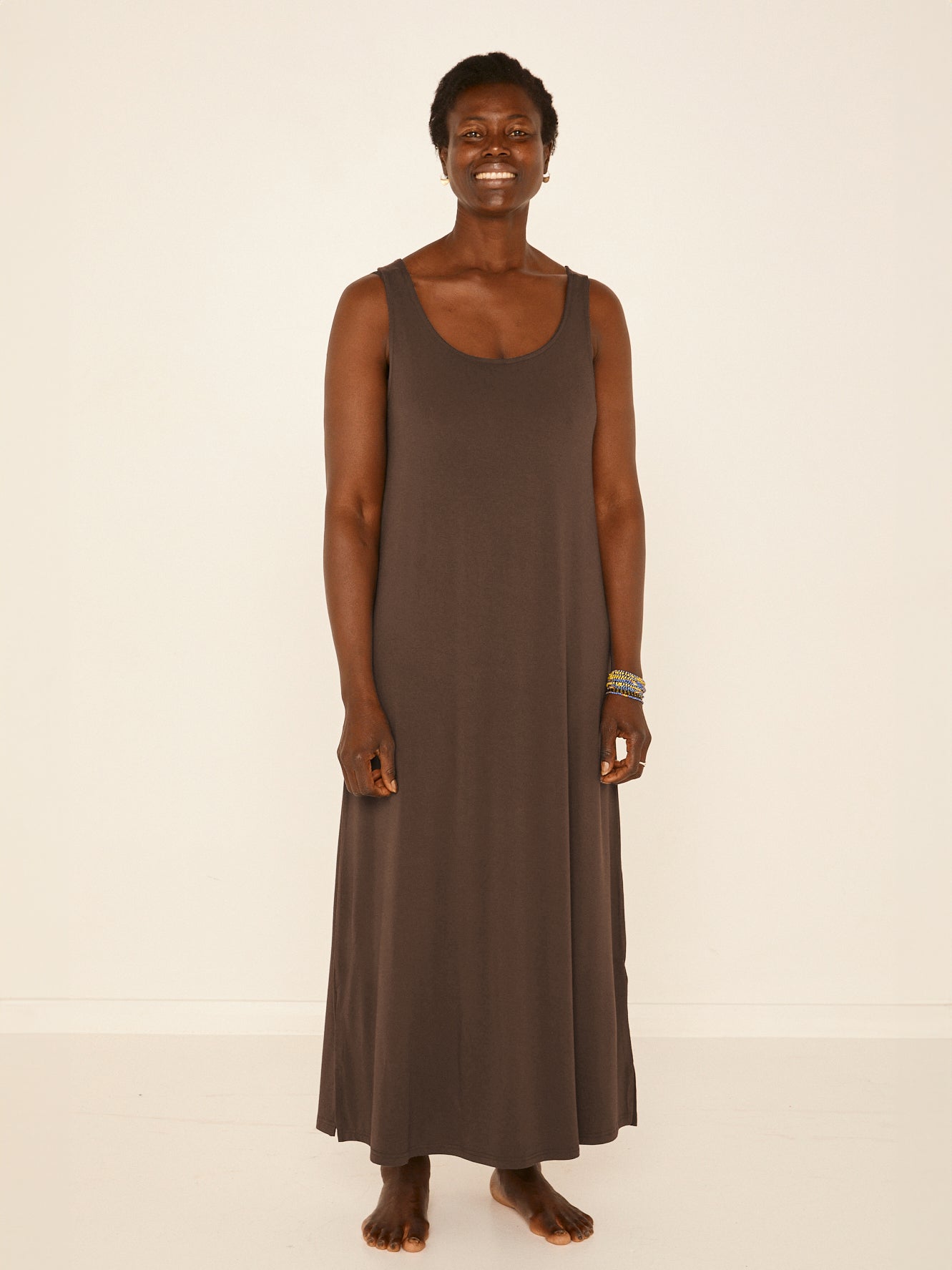 Model wearing a reversible cocoa brown maxi length dress with scoop and boat necklines, women's bamboo clothing