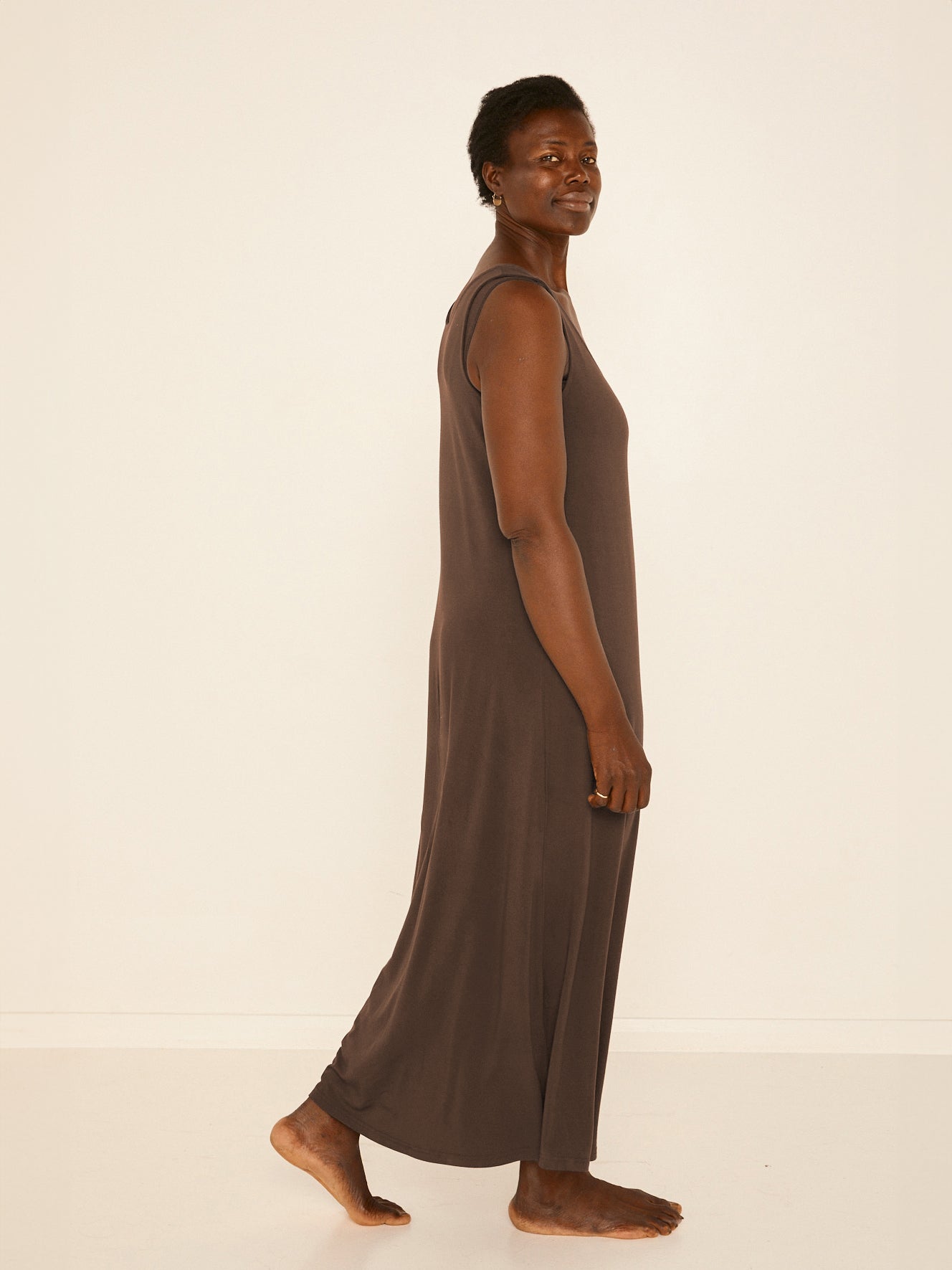 Model wearing a reversible cocoa brown maxi length dress with scoop and boat necklines, women's bamboo clothing