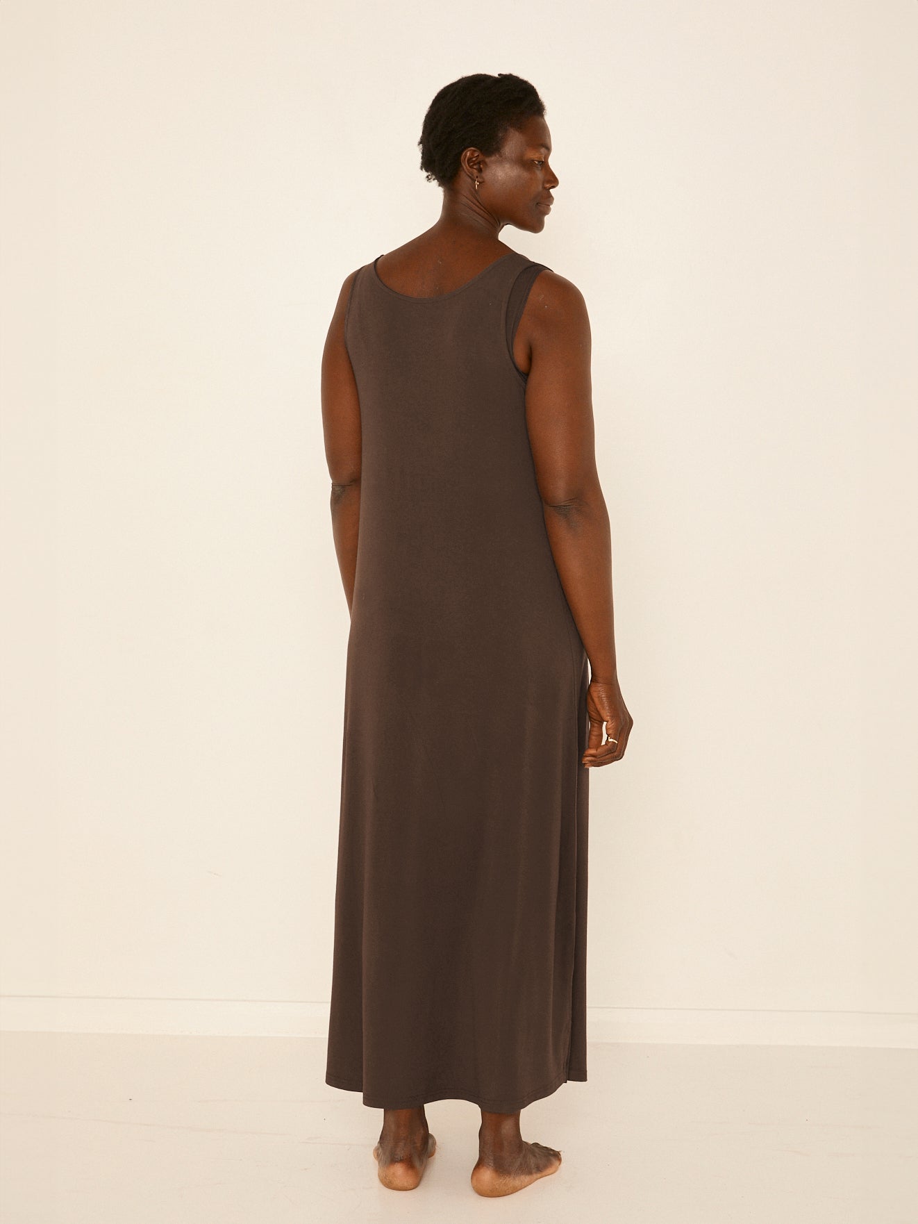 Model wearing a reversible cocoa brown maxi length dress with scoop and boat necklines, women's bamboo clothing