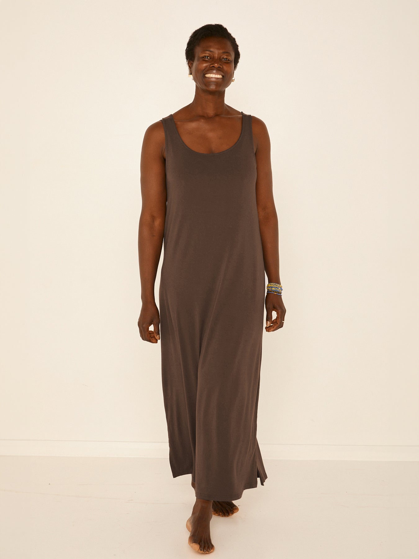 Model wearing a reversible cocoa brown maxi length dress with scoop and boat necklines, women's bamboo clothing