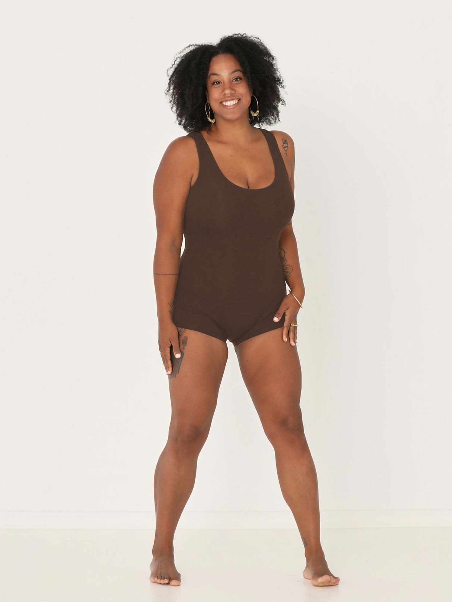 Model wearing a reversible cocoa brown boyleg bodysuit with scoop and boat necklines, women's bamboo clothing