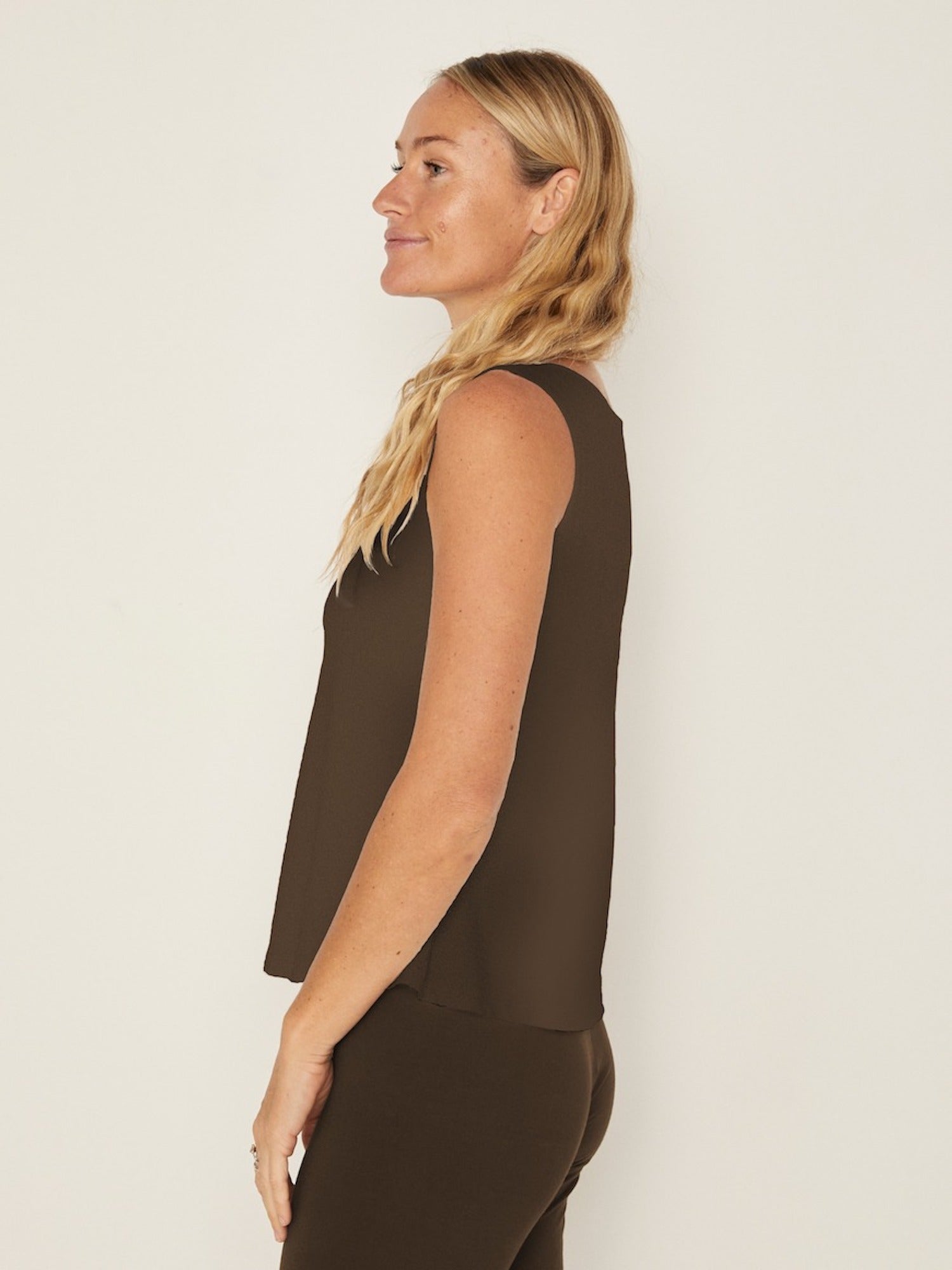 Model wearing a cocoa brown boat neck singlet with wide shoulder coverage, women's bamboo clothing