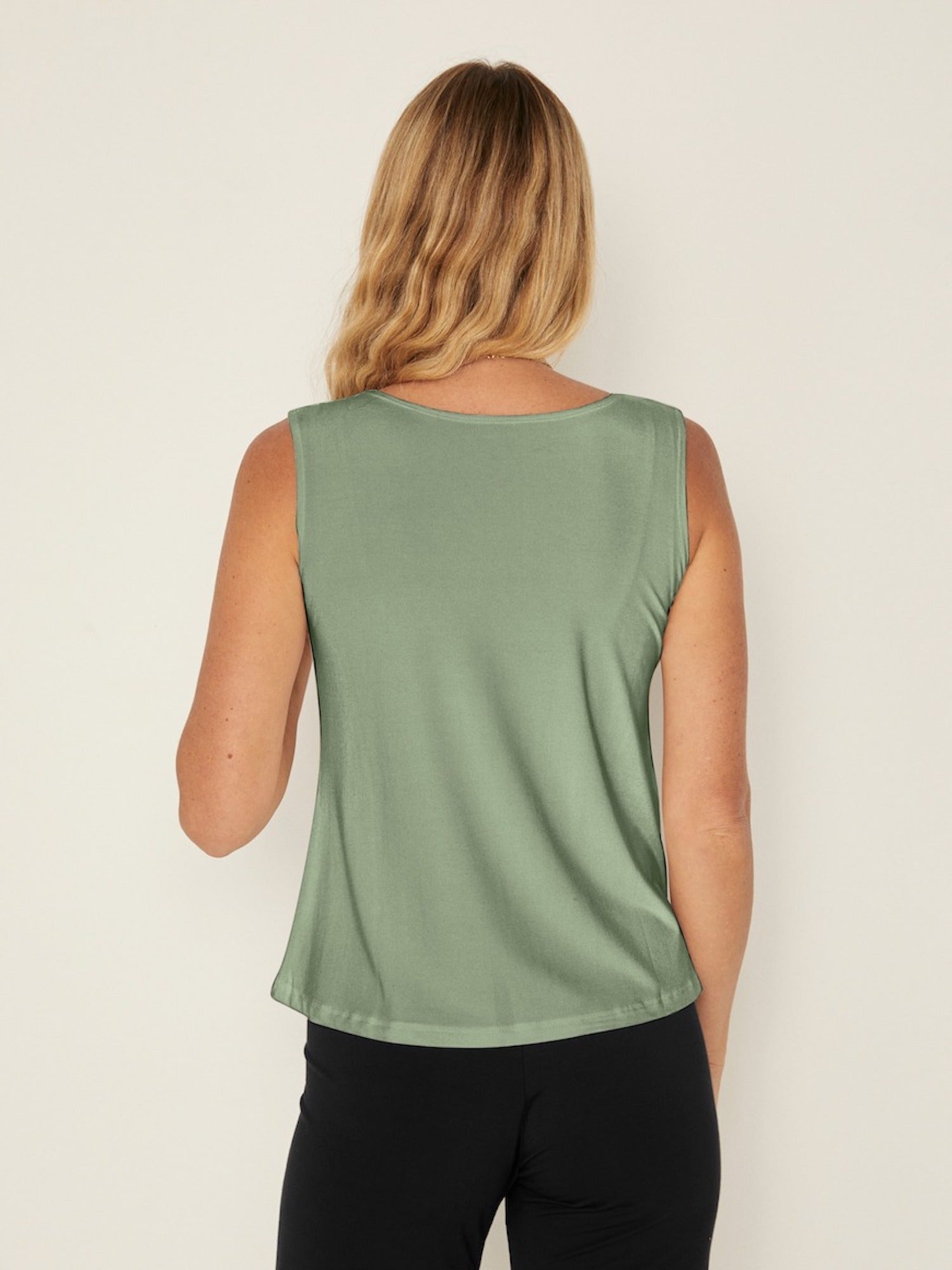 Model wearing a eucalyptus green boat neck singlet with wide shoulder coverage, women's bamboo clothing