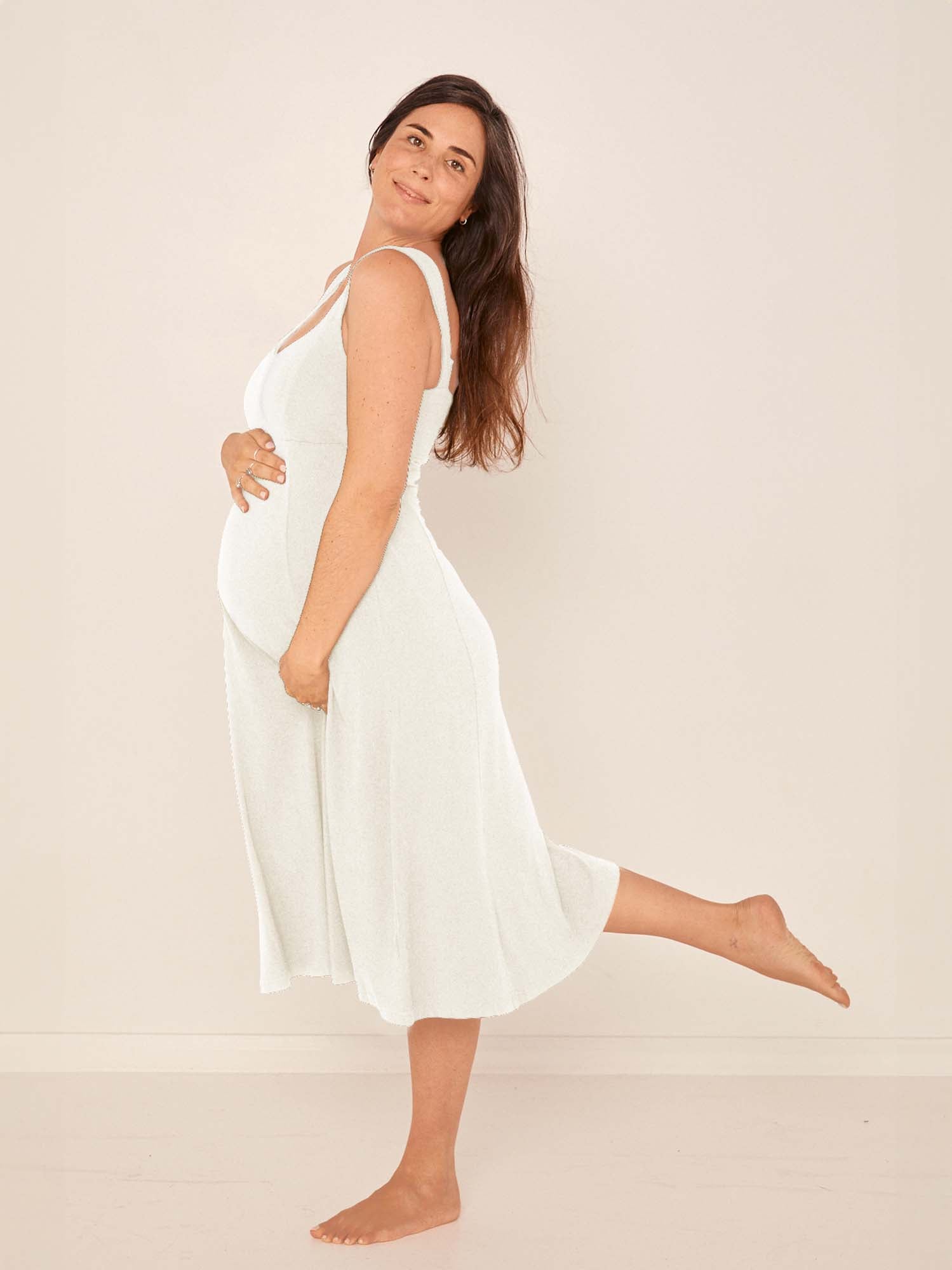 Model wearing a cream mid length, sweetheart neckline swing style dress, women's bamboo clothing