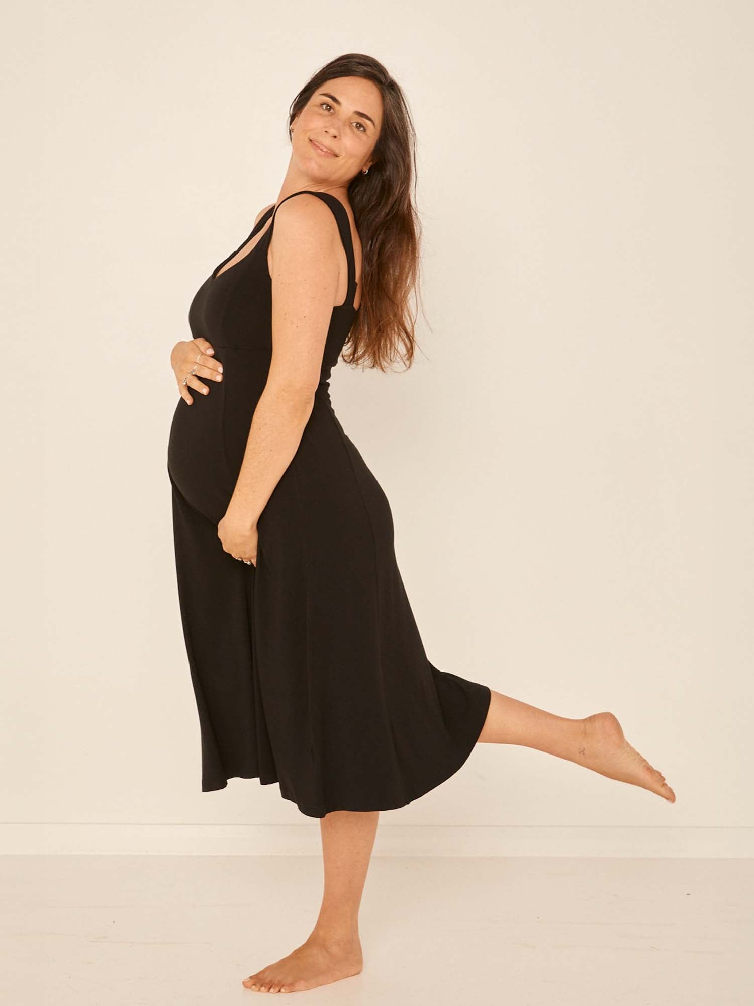 Model wearing a black mid length, sweetheart neckline swing style dress, women's bamboo clothing