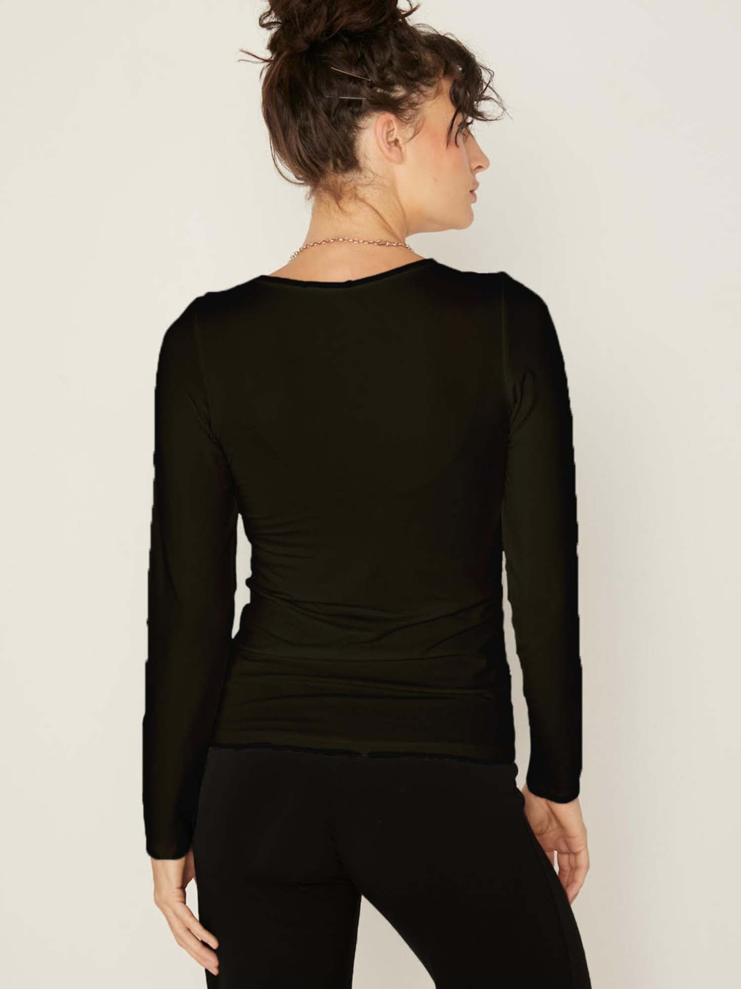Model wearing a reversible black fitted body long sleeve t-shirt with crew and boat necklines, women's bamboo clothing