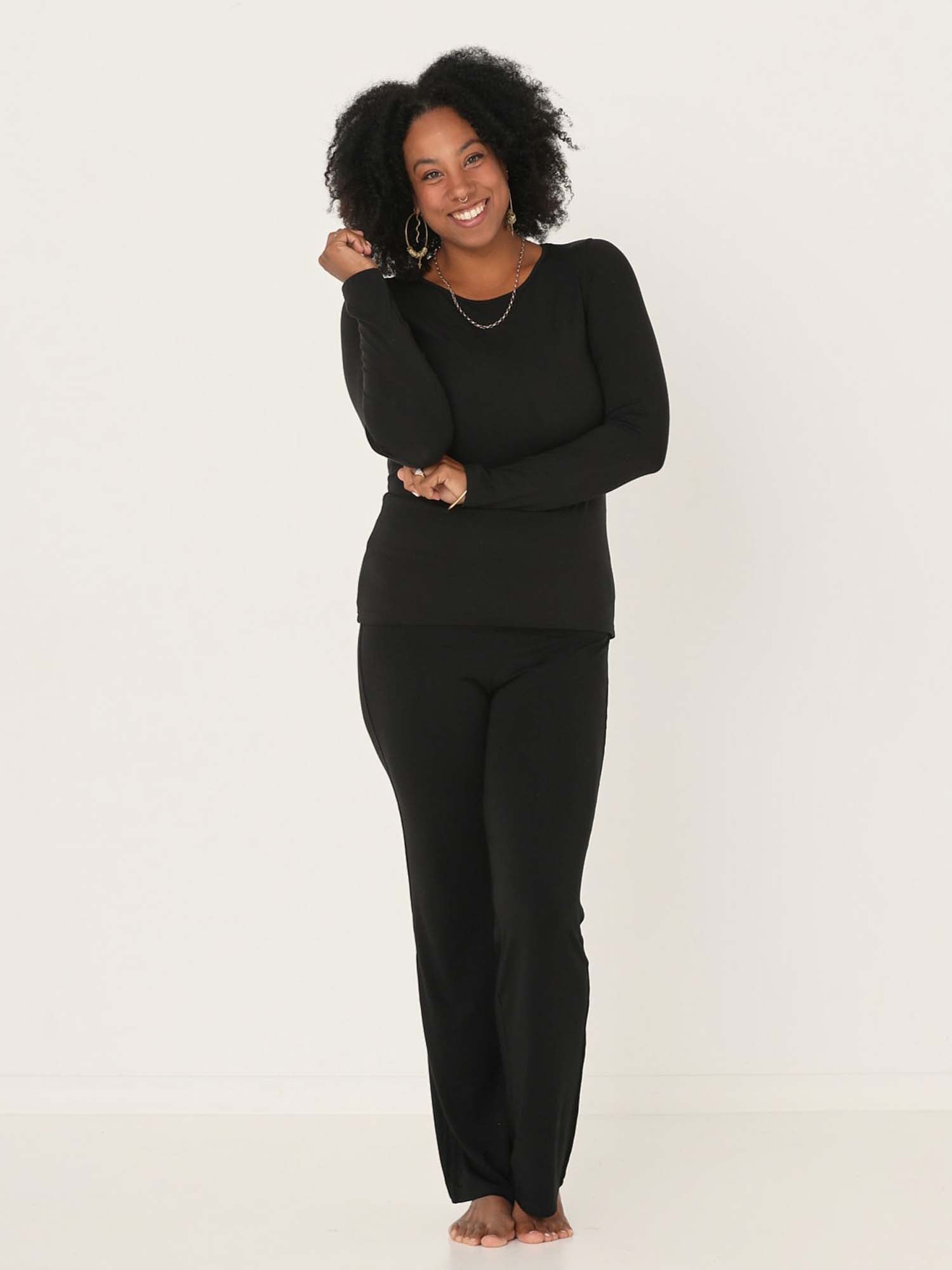 Model wearing a reversible black fitted body long sleeve t-shirt with crew and boat necklines, women's bamboo clothing