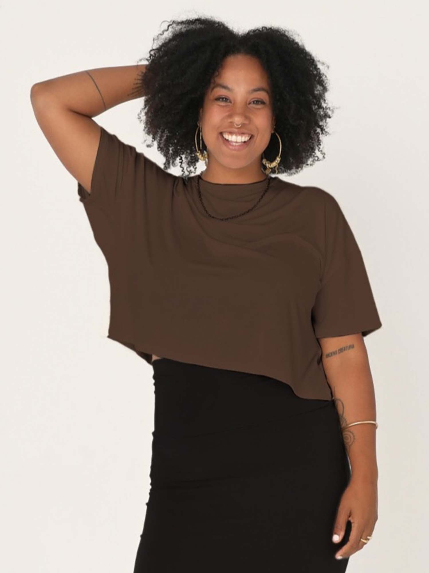 Model wearing a cocoa brown cropped boxy t-shirt, crew neckline, relaxed short sleeve and drop shoulder, women's bamboo clothing