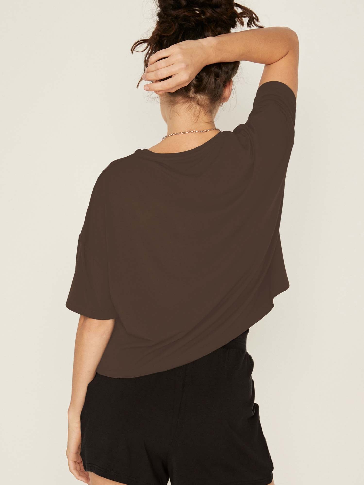 Model wearing a cocoa brown cropped boxy t-shirt, crew neckline, relaxed short sleeve and drop shoulder, women's bamboo clothing