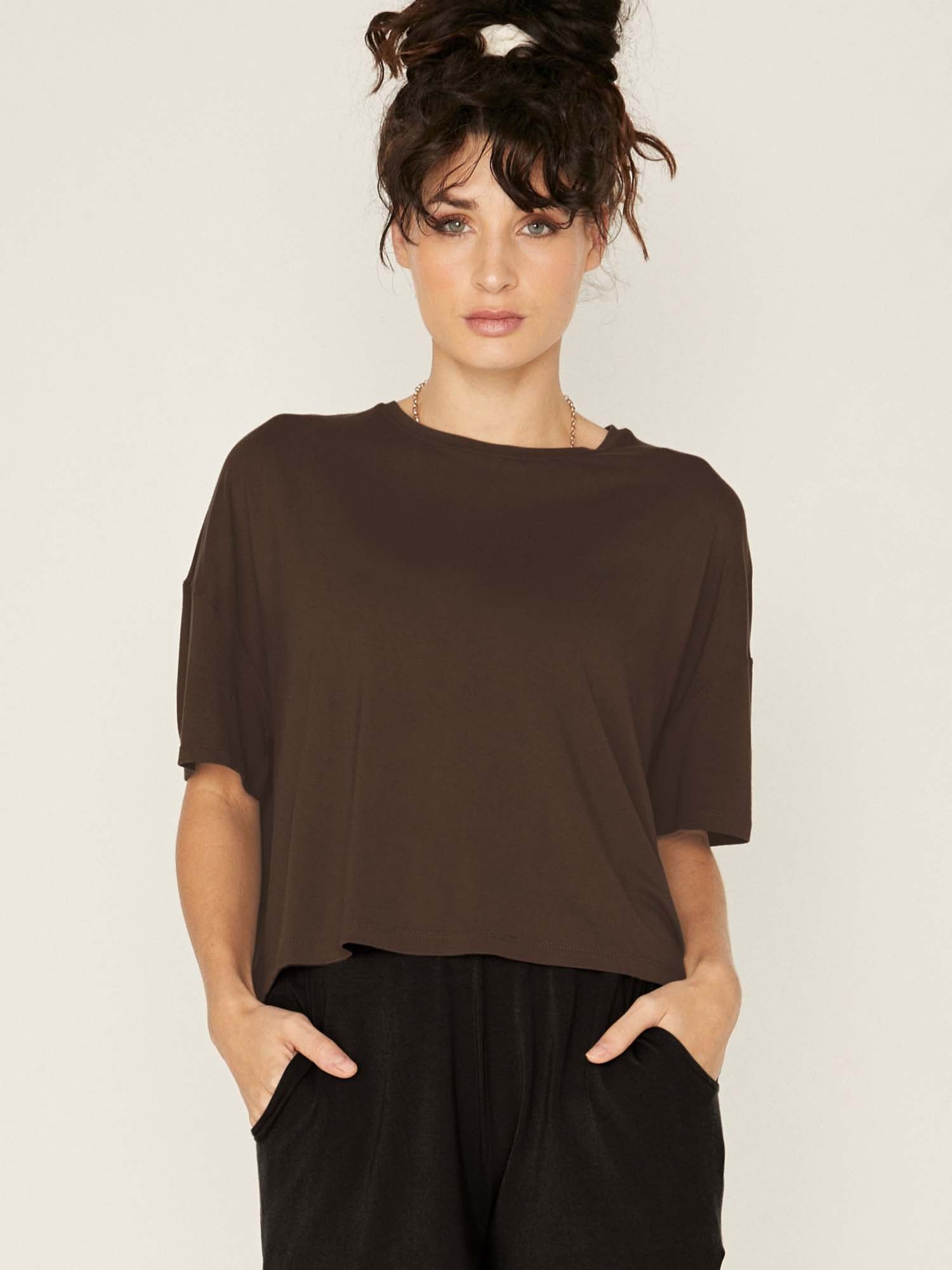 Model wearing a cocoa brown cropped boxy t-shirt, crew neckline, relaxed short sleeve and drop shoulder, women's bamboo clothing