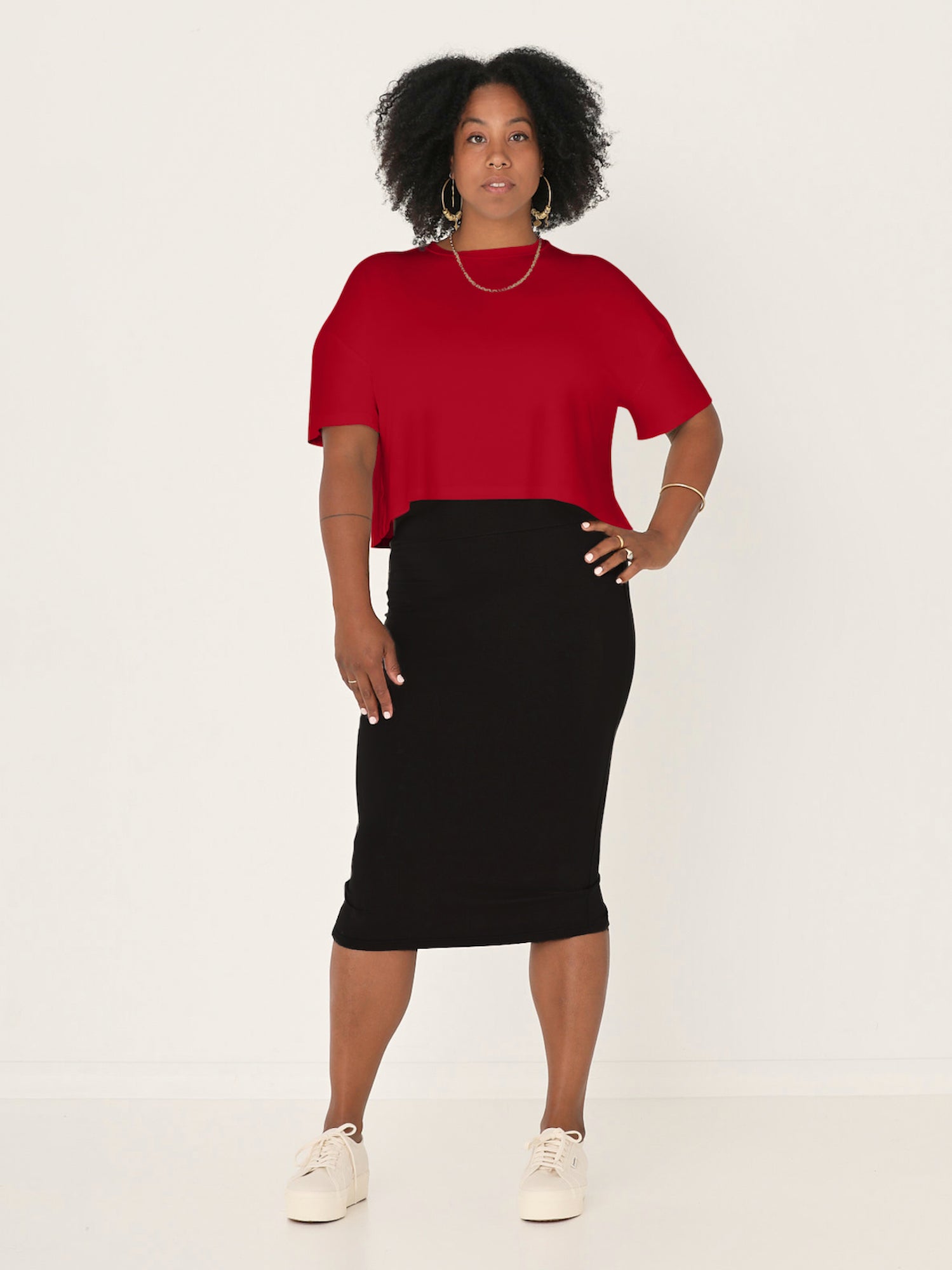 Model wears chili pepper red bamboo lounge tee in a crew neck style with a slight crop length and a black tube pencil skirt, womens bamboo clothing
