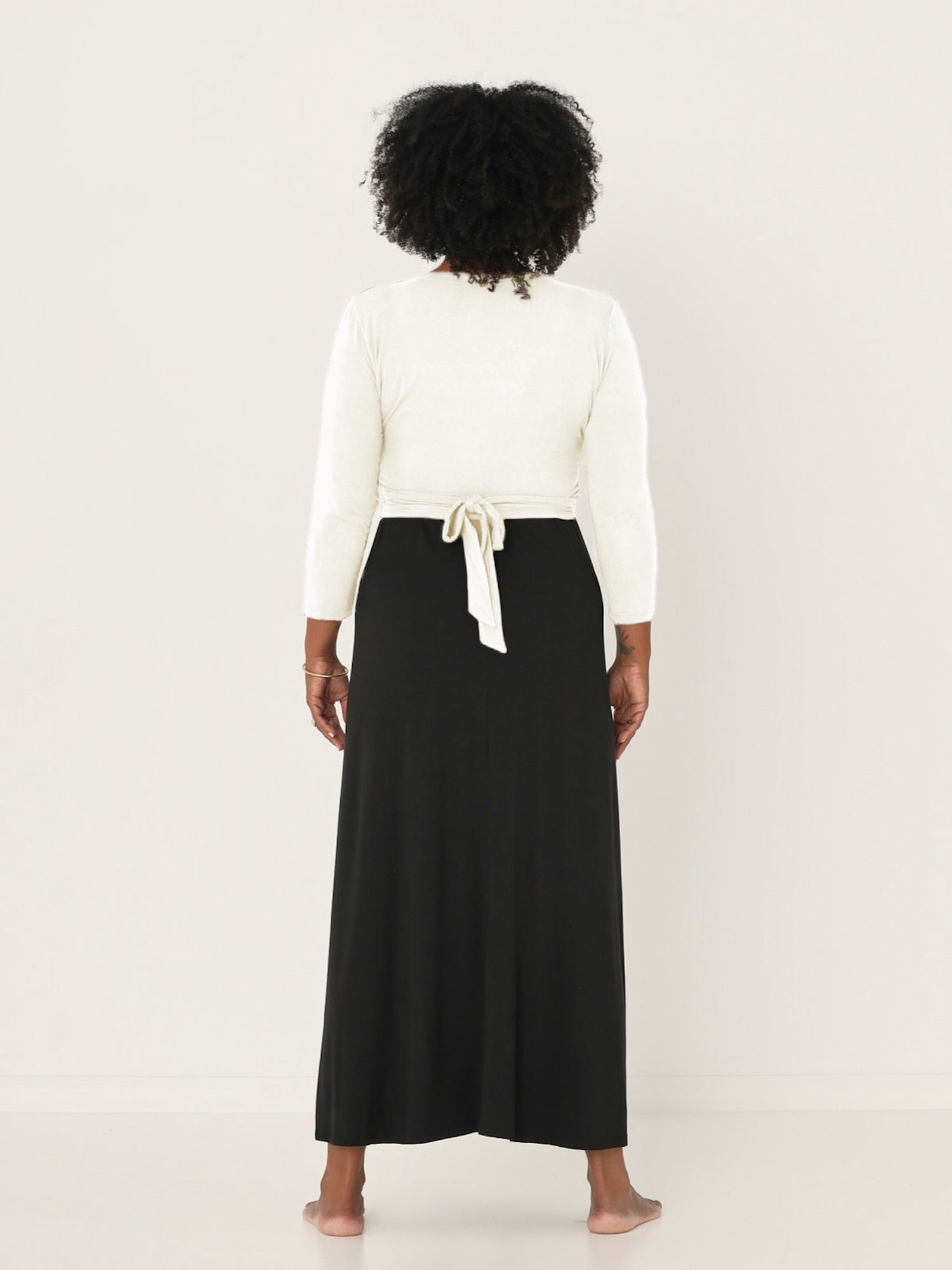 Model wearing a cream ballet wrap cardigan with plunge neckline and fitted 3/4 sleeves, women's bamboo clothing