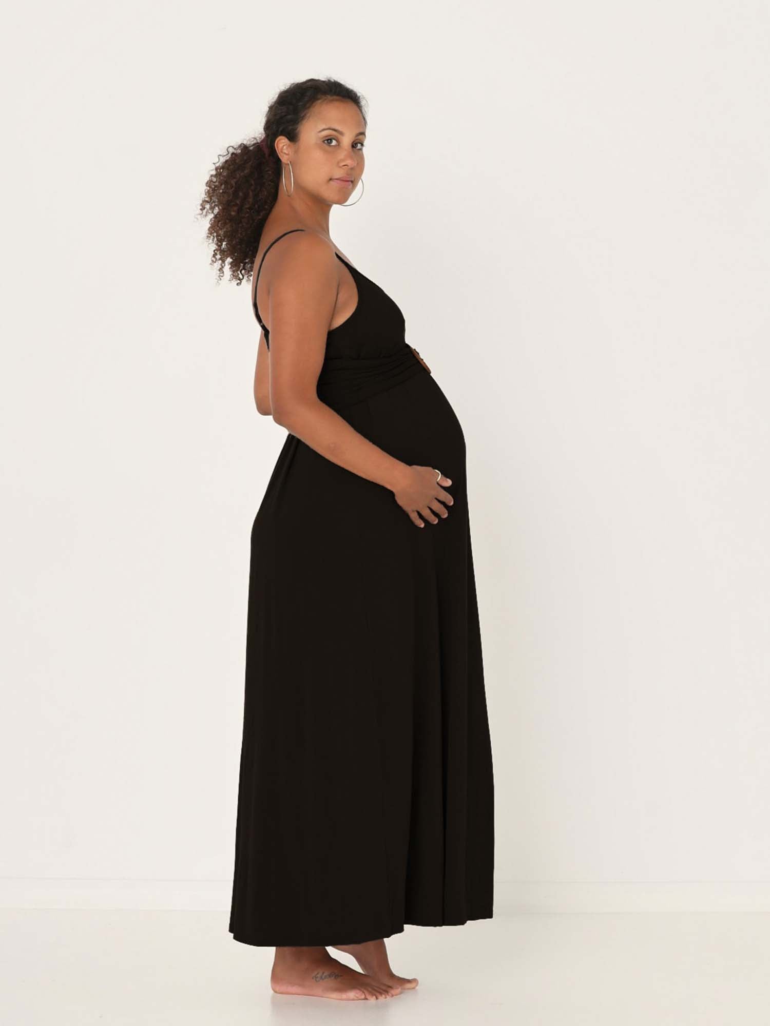 Model wearing a black swing maxi dress with a scoop neck and elasticated camisole straps, women's bamboo clothing