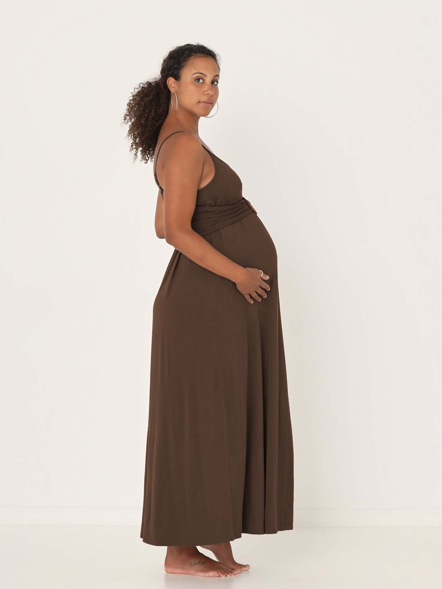 Model wearing a cocoa brown swing maxi dress with a scoop neck and elasticated camisole straps, women's bamboo clothing