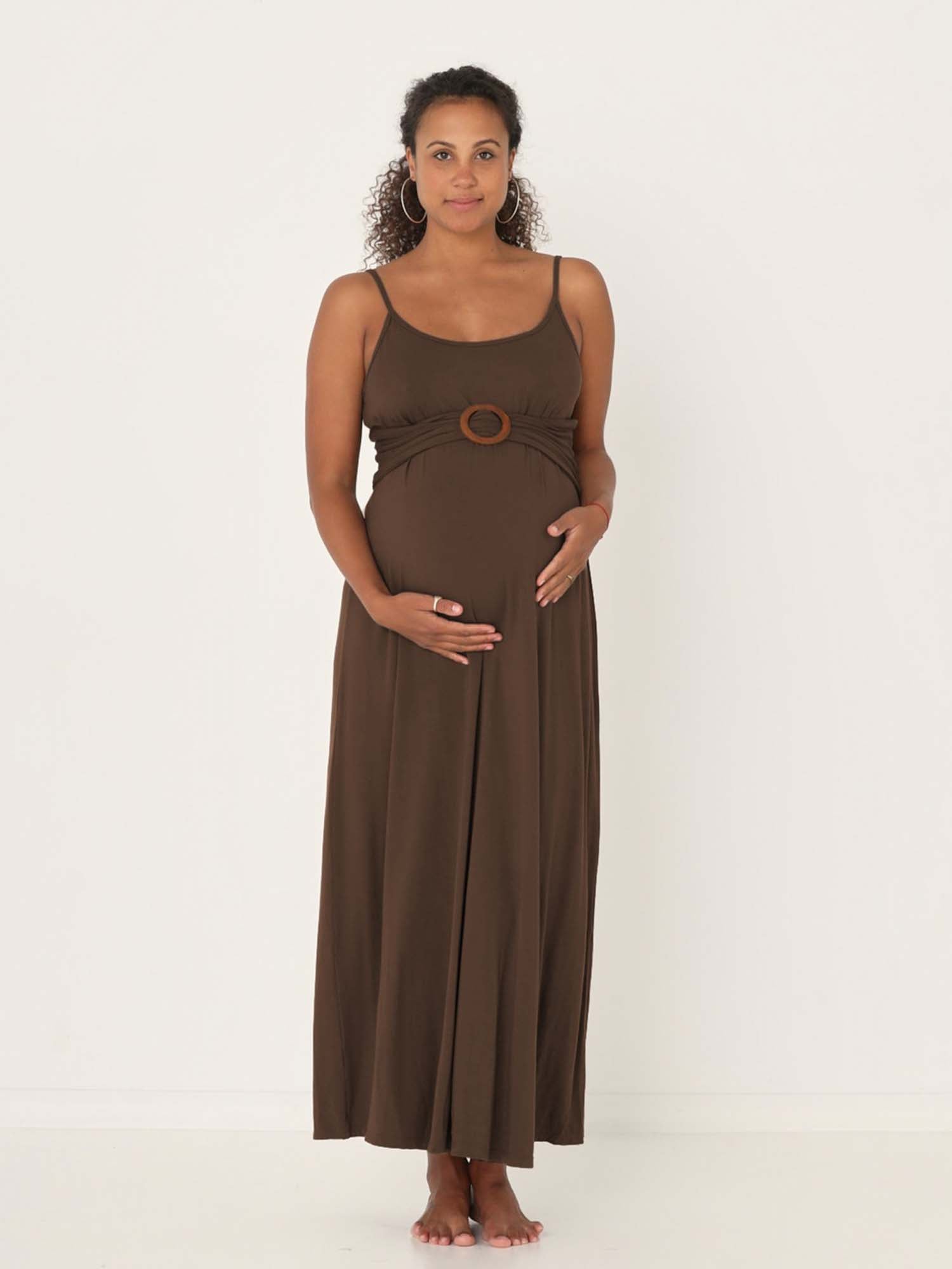 Model wearing a cocoa brown swing maxi dress with a scoop neck and elasticated camisole straps, women's bamboo clothing