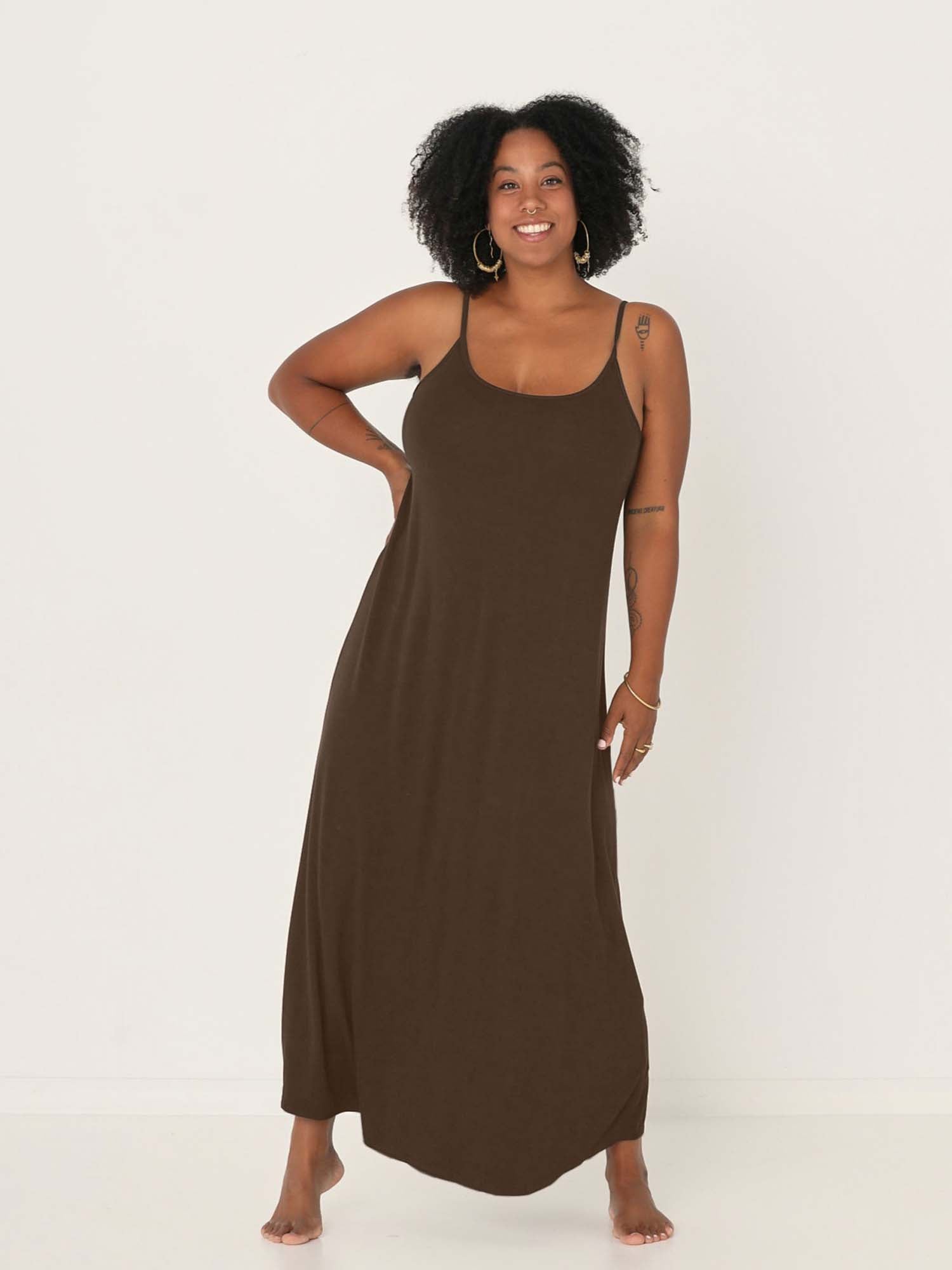 Model wearing a cocoa brown swing maxi dress with a scoop neck and elasticated camisole straps, women's bamboo clothing