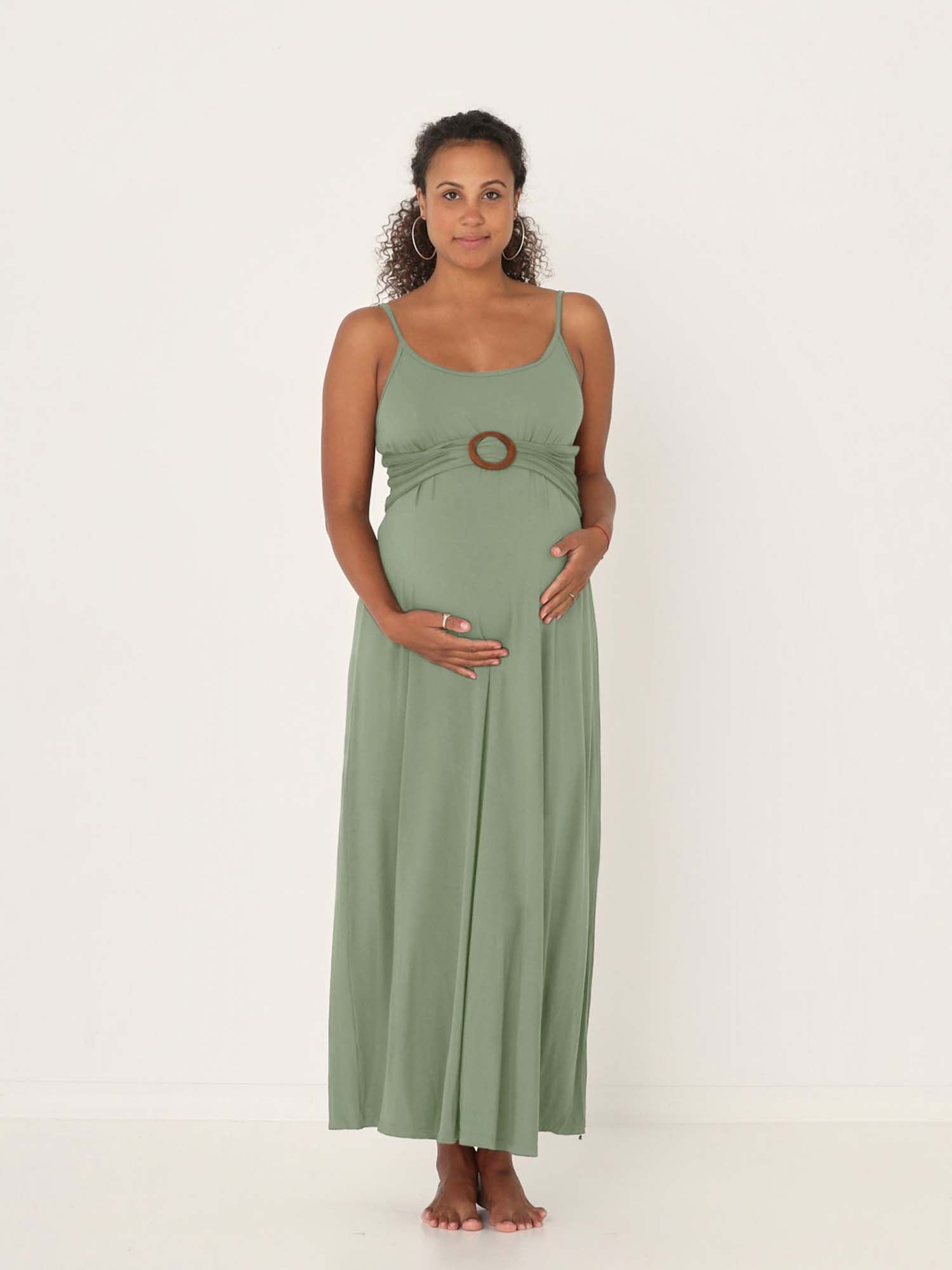 Model wearing a eucalyptus green swing maxi dress with a scoop neck and elasticated camisole straps, women's bamboo clothing