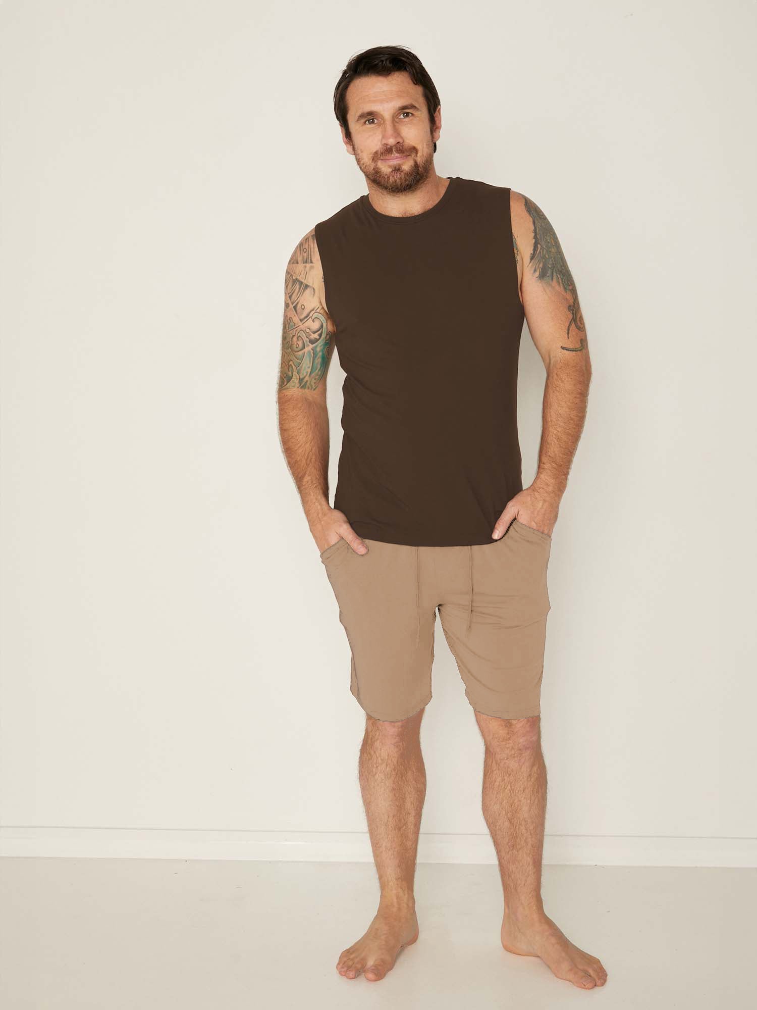 Male model wears Bamboo Casual Shorts in Caramel and Men's Tank Singlet in Cocoa