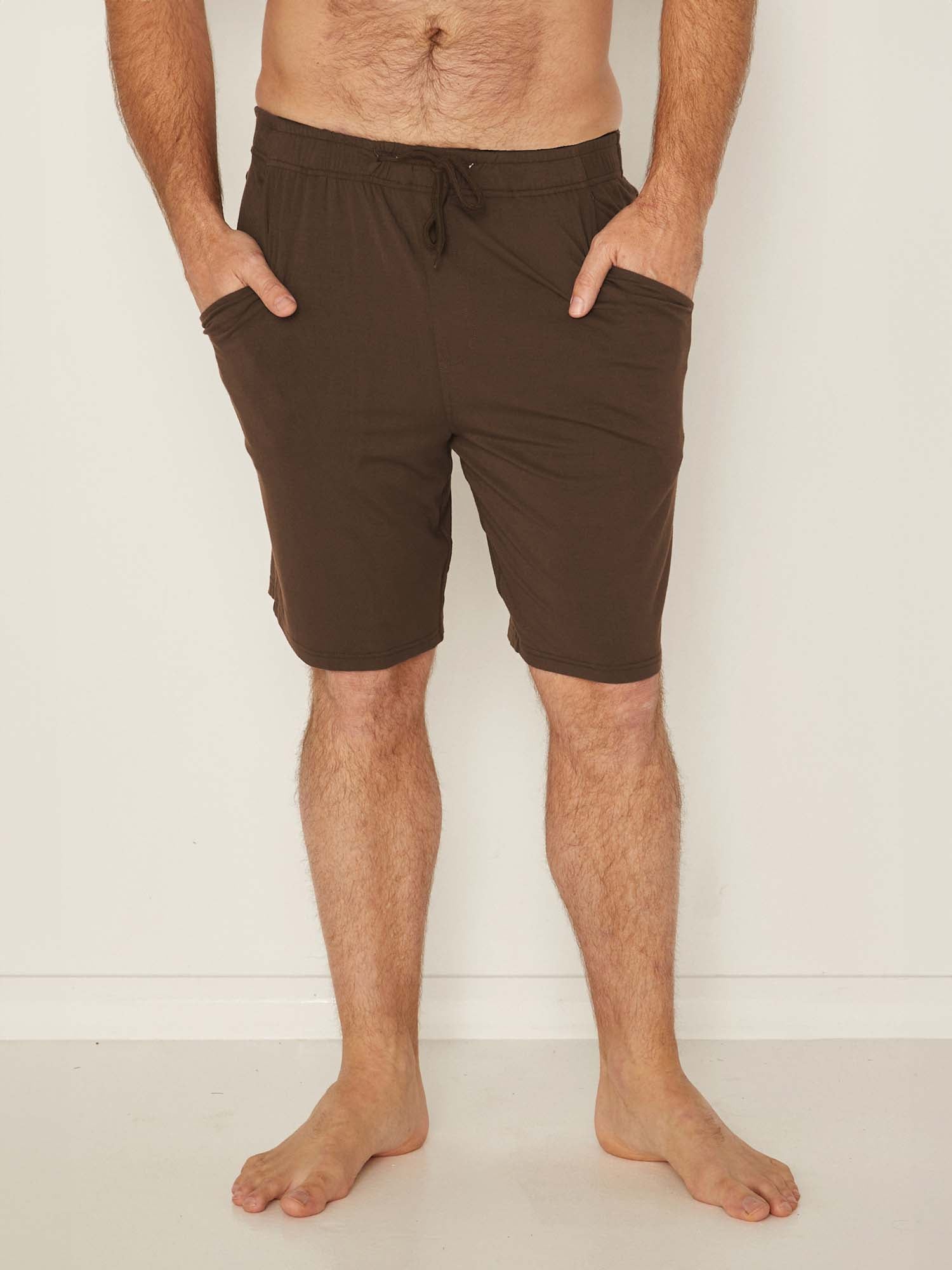 Male model wearing knee length cocoa brown casual shorts with elasticised waist and deep pockets, men's bamboo clothing