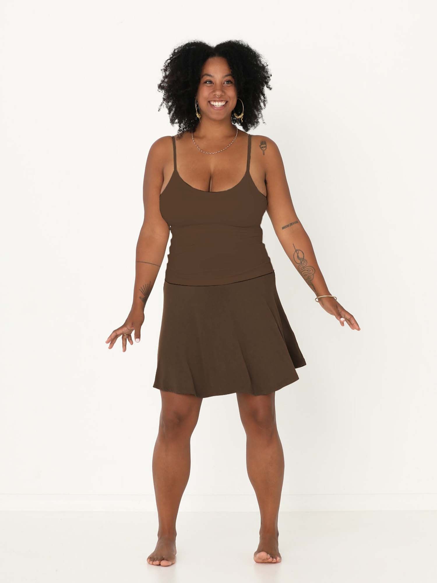 Model wearing cocoa brown knee length swing style swishy mini skirt with adjustable high waistband, women's bamboo clothing