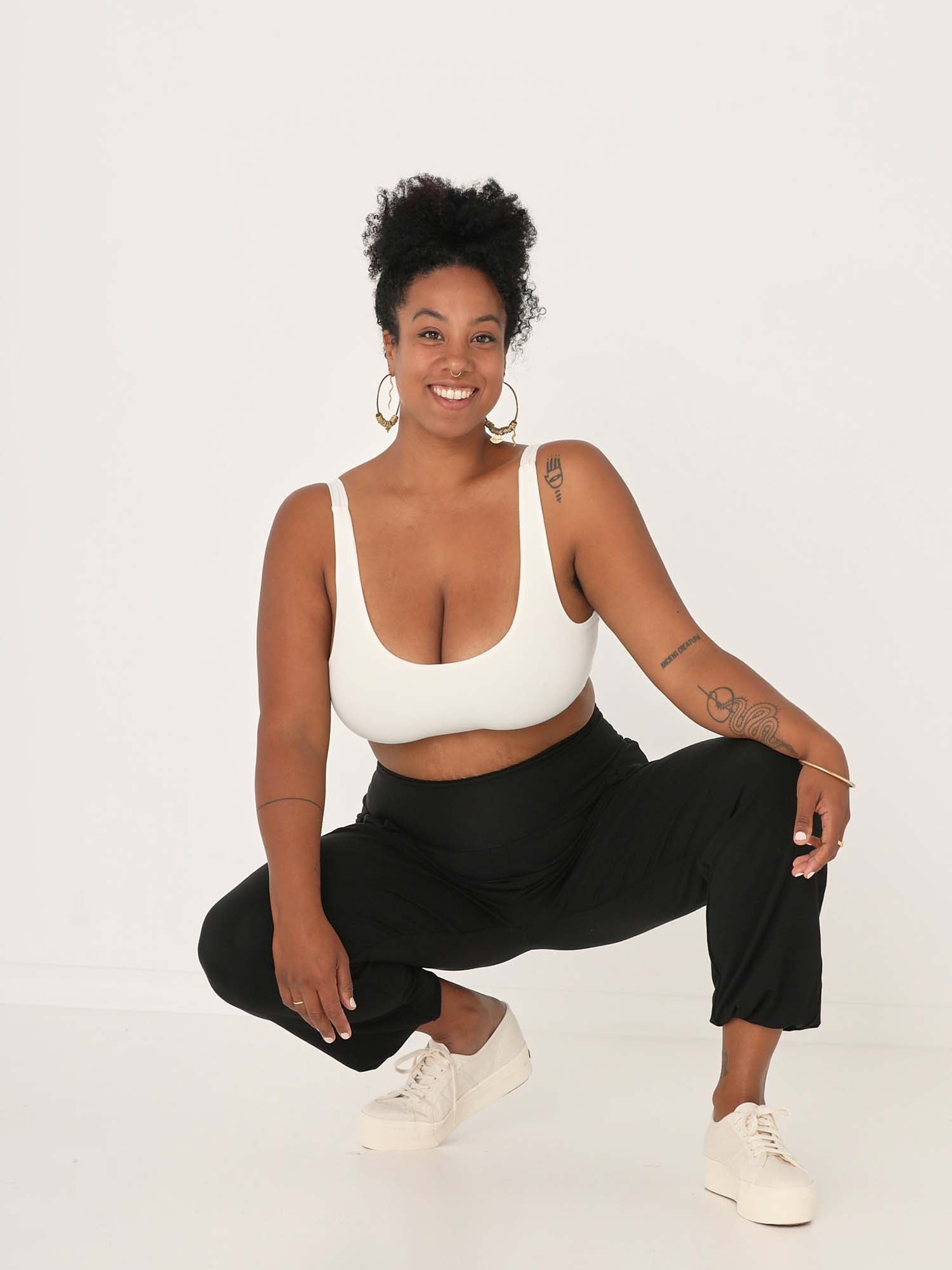 Model wearing black lounge pants with a deep waistband, long relaxed leg, elasticised cuff and side pockets, women's bamboo clothing