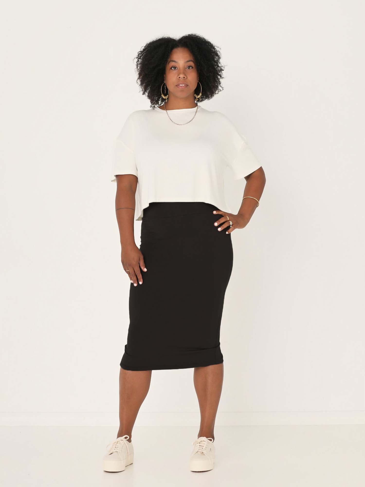 Model wearing black midi pencil tube skirt, mid calf length with a deep waistband, women's bamboo clothing