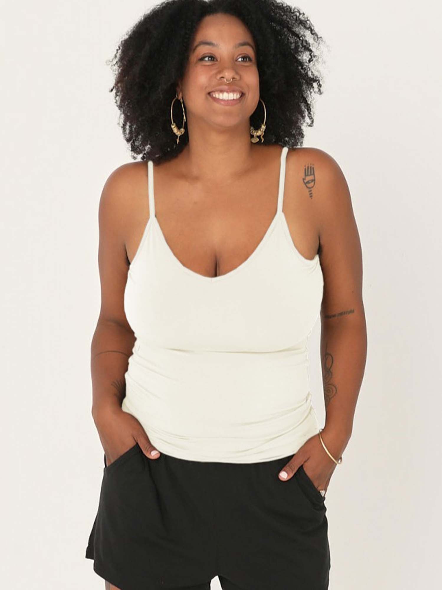 Model wearing a cream layering singlet with camisole straps, v neckline and fitted body, women's bamboo clothing