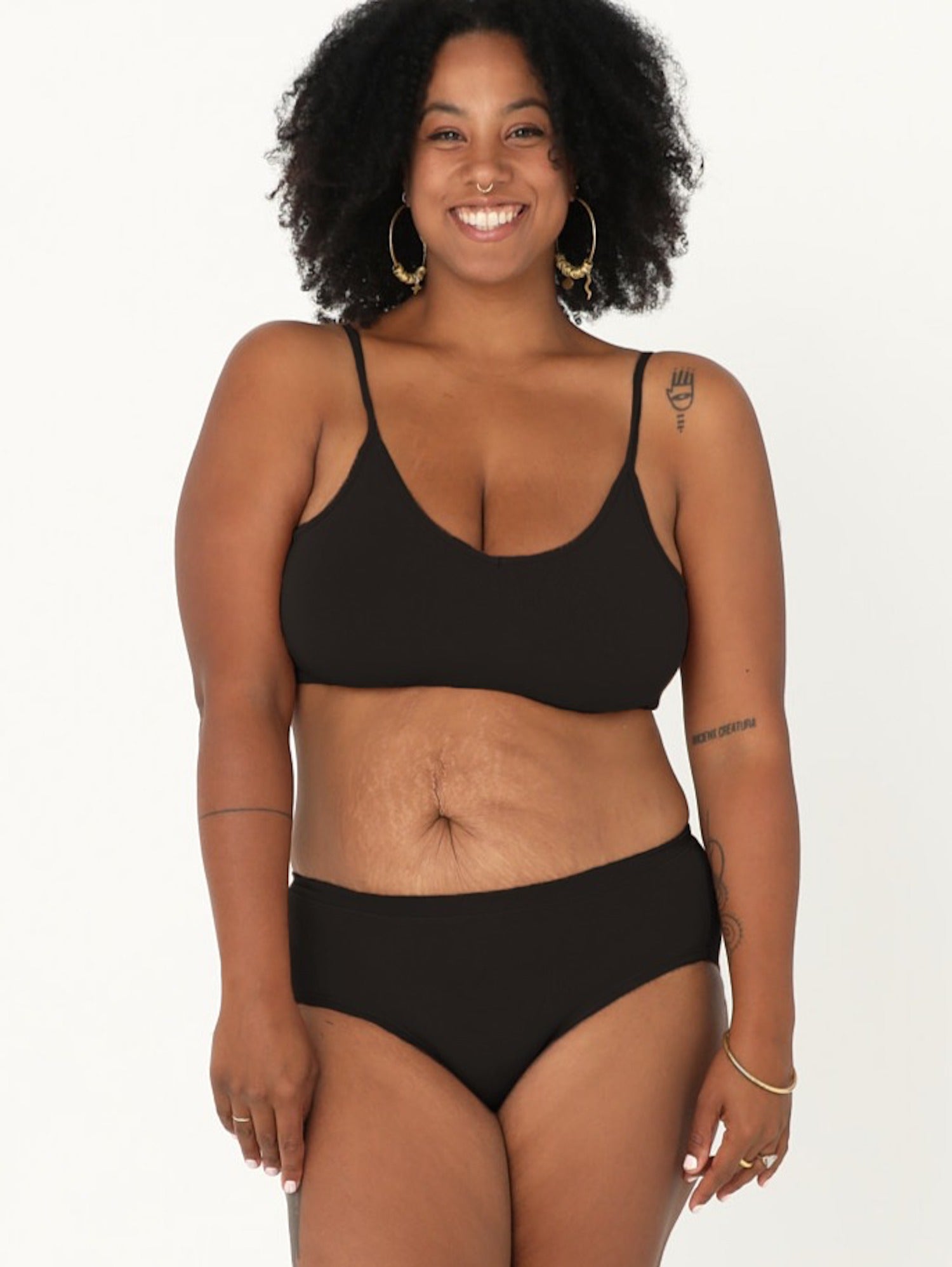 Model wearing a black full brief with mid waist and soft leg banding to lift and shape bottom, women's bamboo underwear