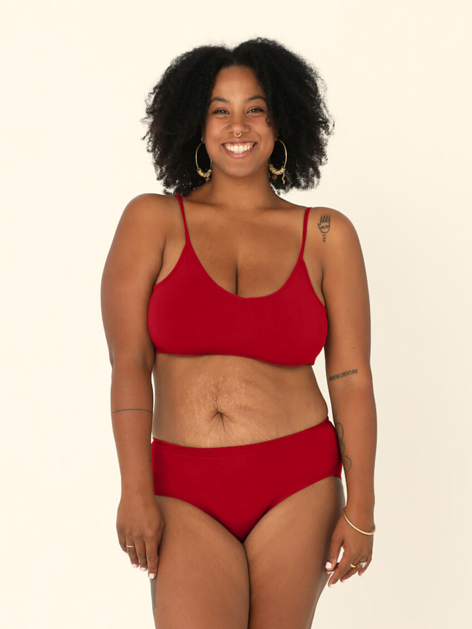model wears Chili pepper red mid-waisted bamboo underpants and yoga top bra on a white background
