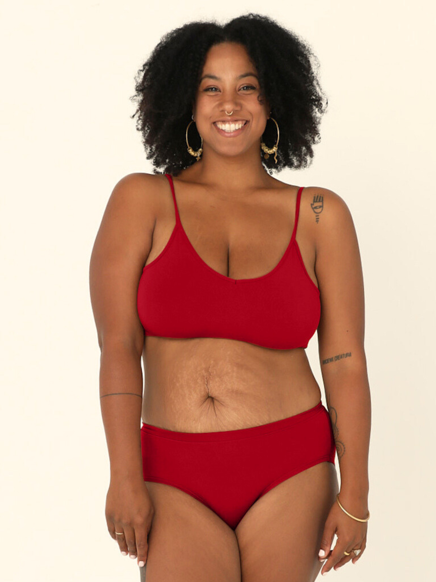 Model wearing chili pepper red wireless yoga bra, subtle v front, soft cup bralette with adjustable camisole straps with matching red full brief undies, women's bamboo underwear