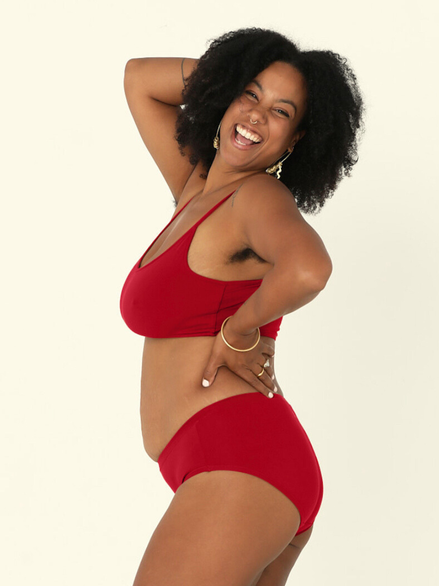 model wears Chili pepper red mid-waisted bamboo underpants and yoga top bra on a white background