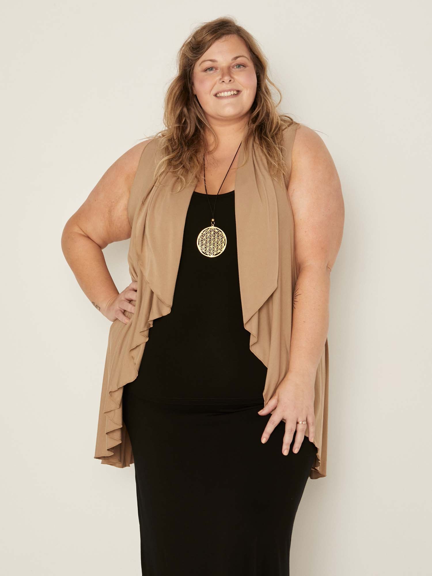 Model wearing a caramel brown convertible style goddess wrap; long cardi, vest or poncho, women's bamboo clothing