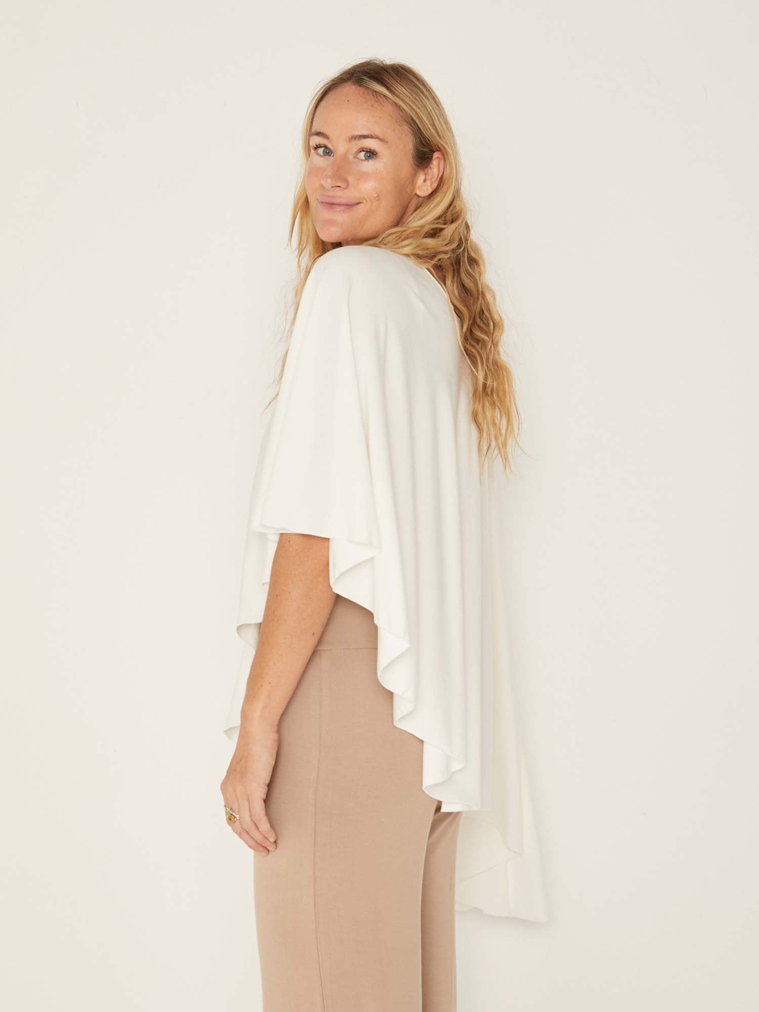 Model wearing a cream convertible style goddess wrap; long cardi, vest or poncho, women's bamboo clothing