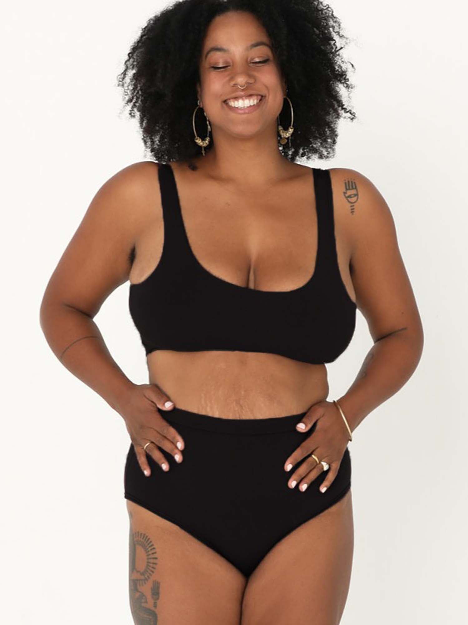 Model wearing black high waisted full brief with mid leg opening and double layered waistband, women's bamboo underwear