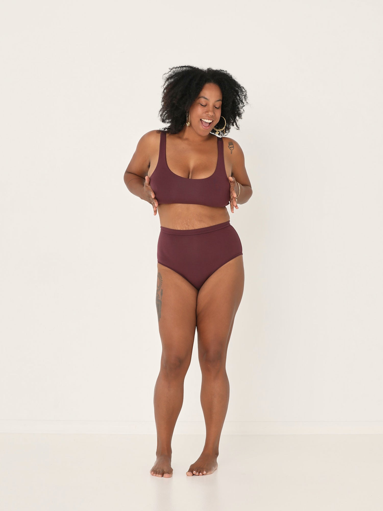 Woman wearing a aubergine marooon reversible bra and high waisted full brief bamboo undies set on a white background, womens bamboo underwear