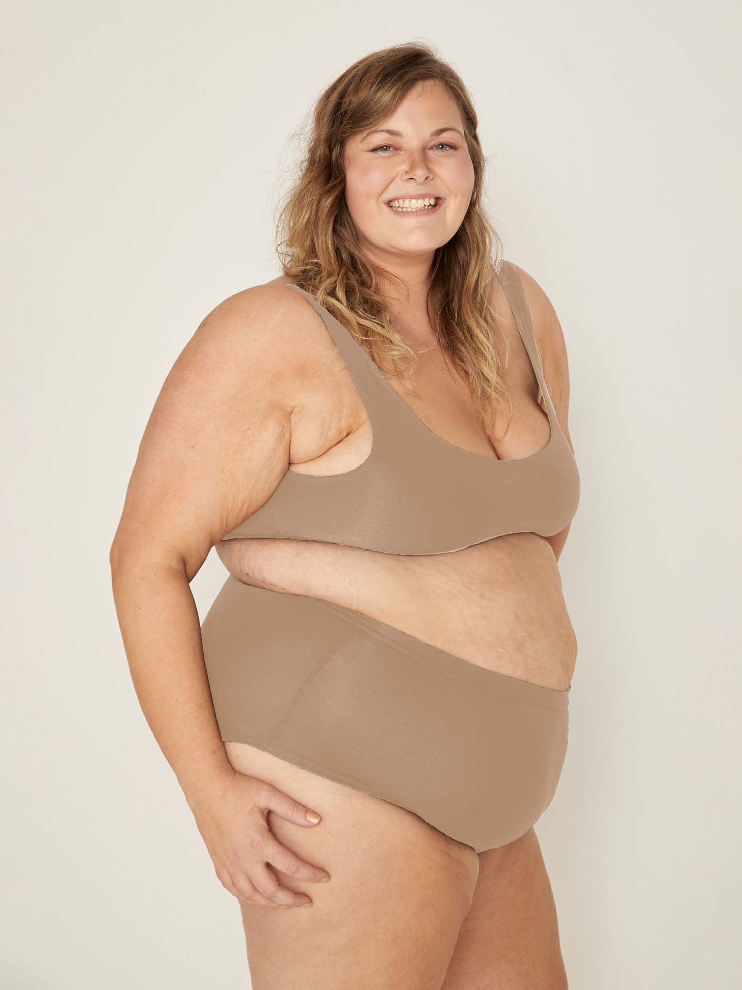 Model wearing caramel high waisted full brief with mid leg opening and double layered waistband, women's bamboo underwear