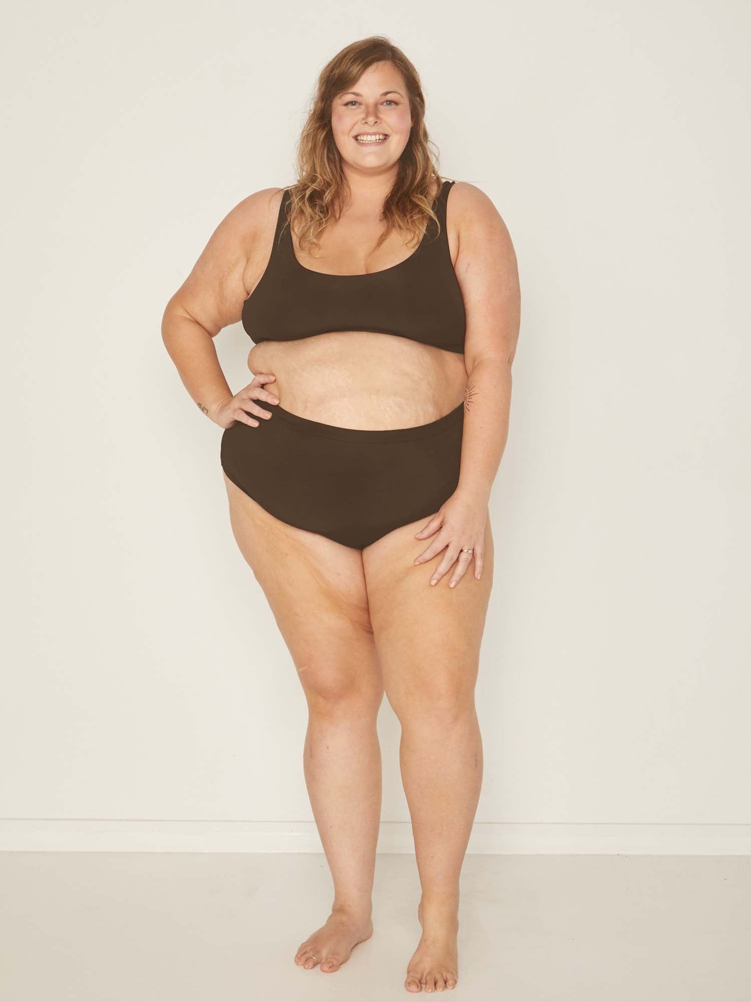 Model wearing cocoa brown high waisted full brief with mid leg opening and double layered waistband, women's bamboo underwear