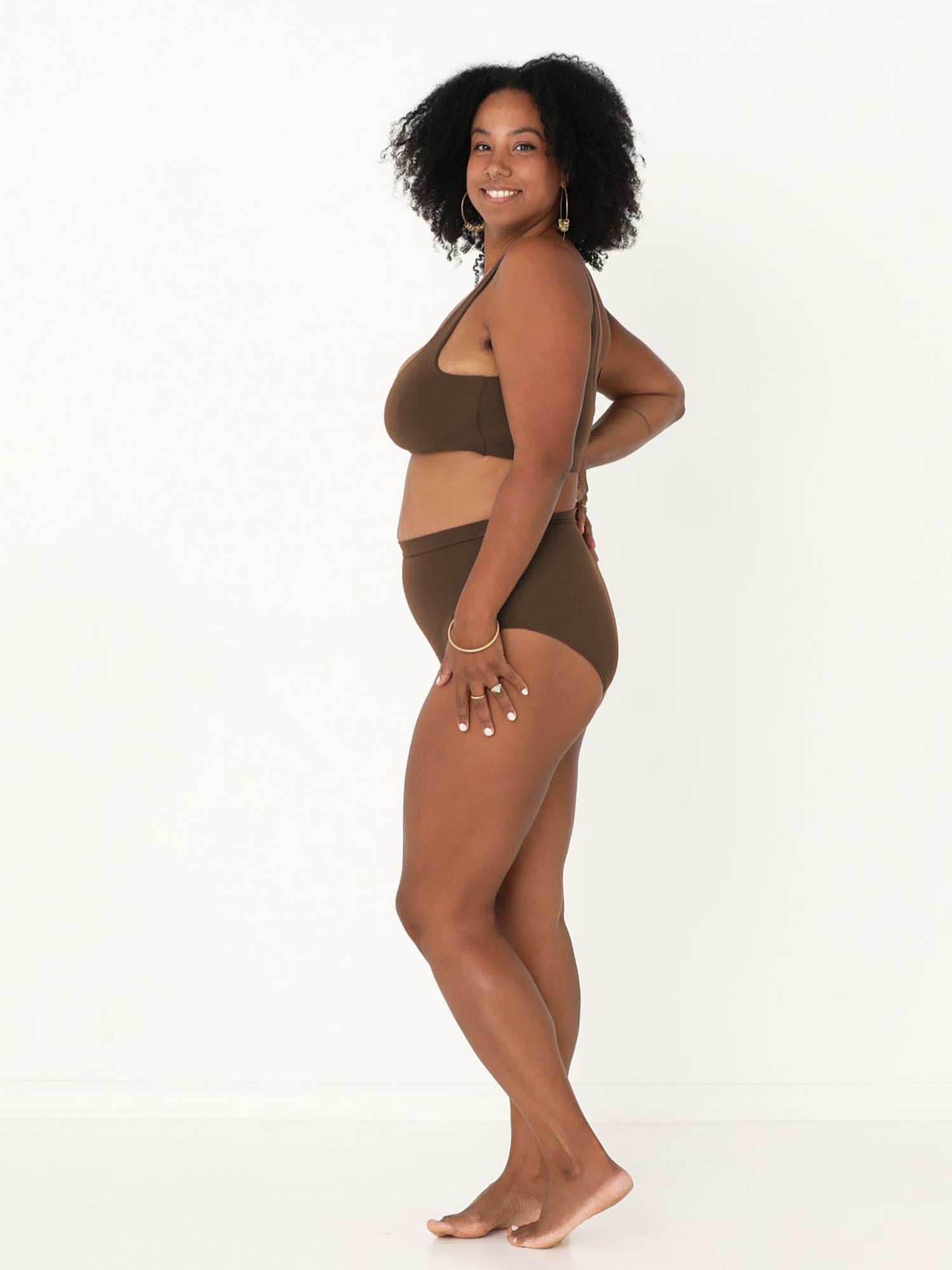 Model wearing cocoa brown high waisted full brief with mid leg opening and double layered waistband, women's bamboo underwear