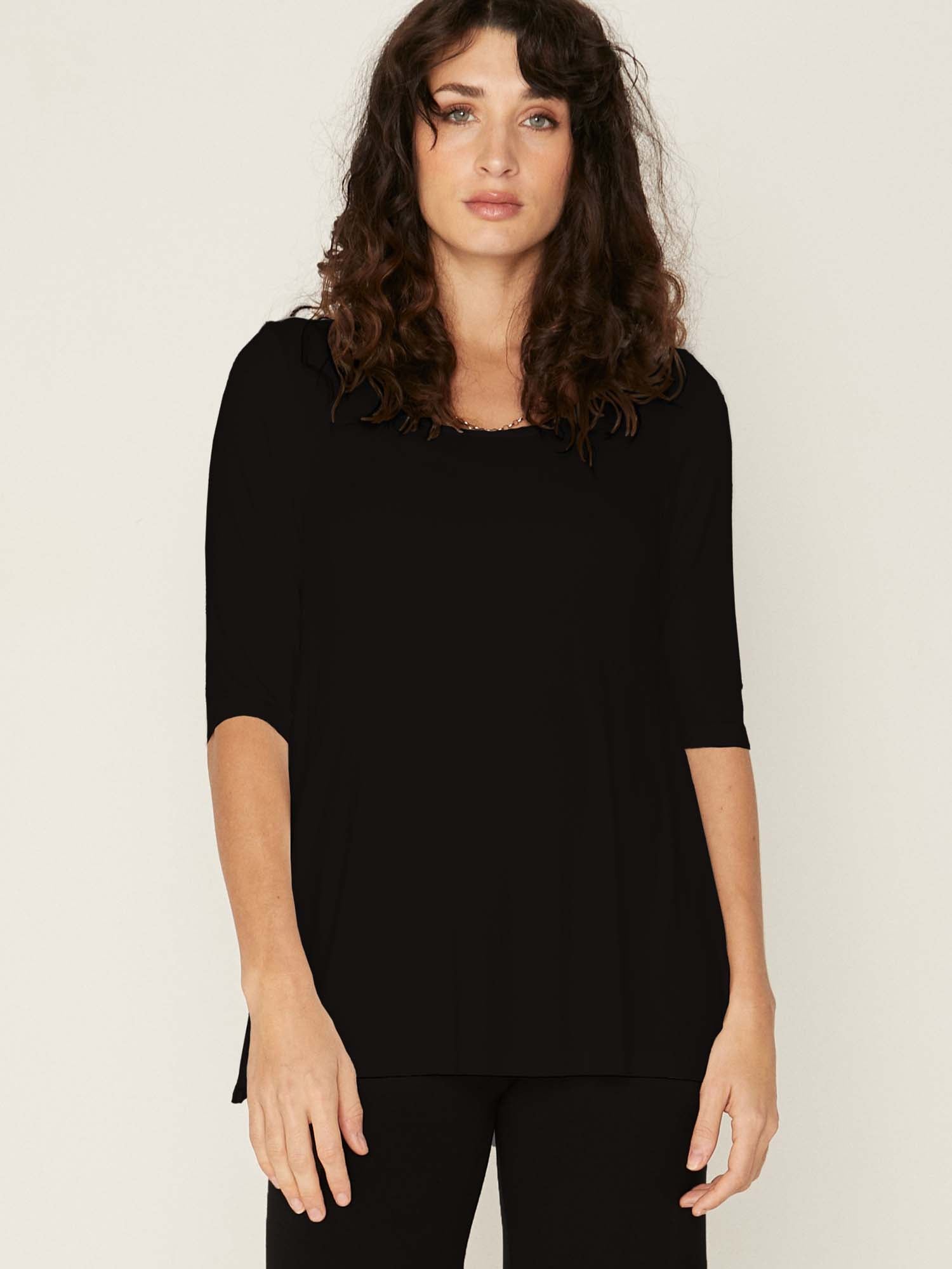 Model wearing a reversible black mid sleeve t-shirt with scoop and boat necklines, a-line long line body, women's bamboo clothing