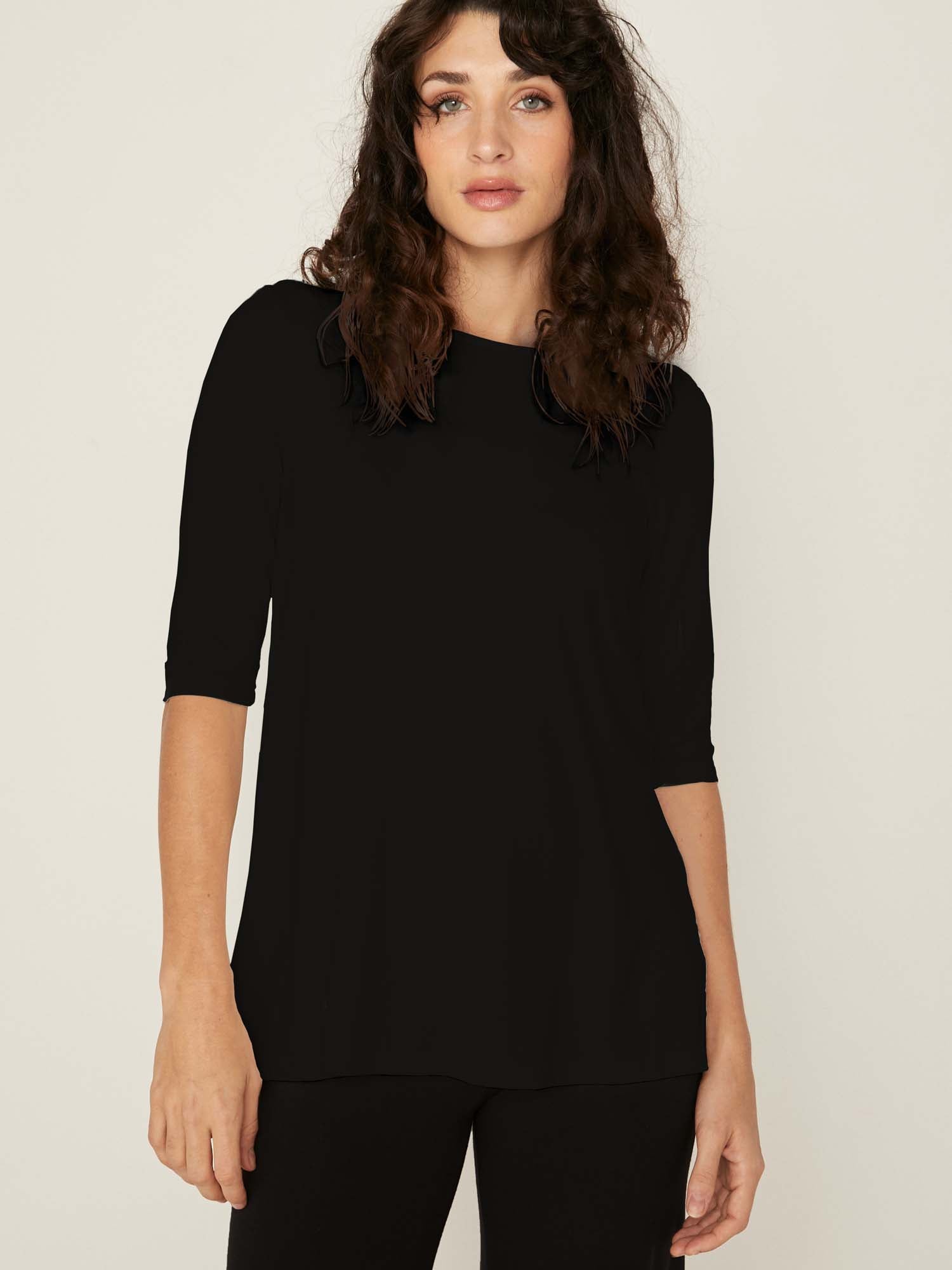 Model wearing a reversible black mid sleeve t-shirt with scoop and boat necklines, a-line long line body, women's bamboo clothing