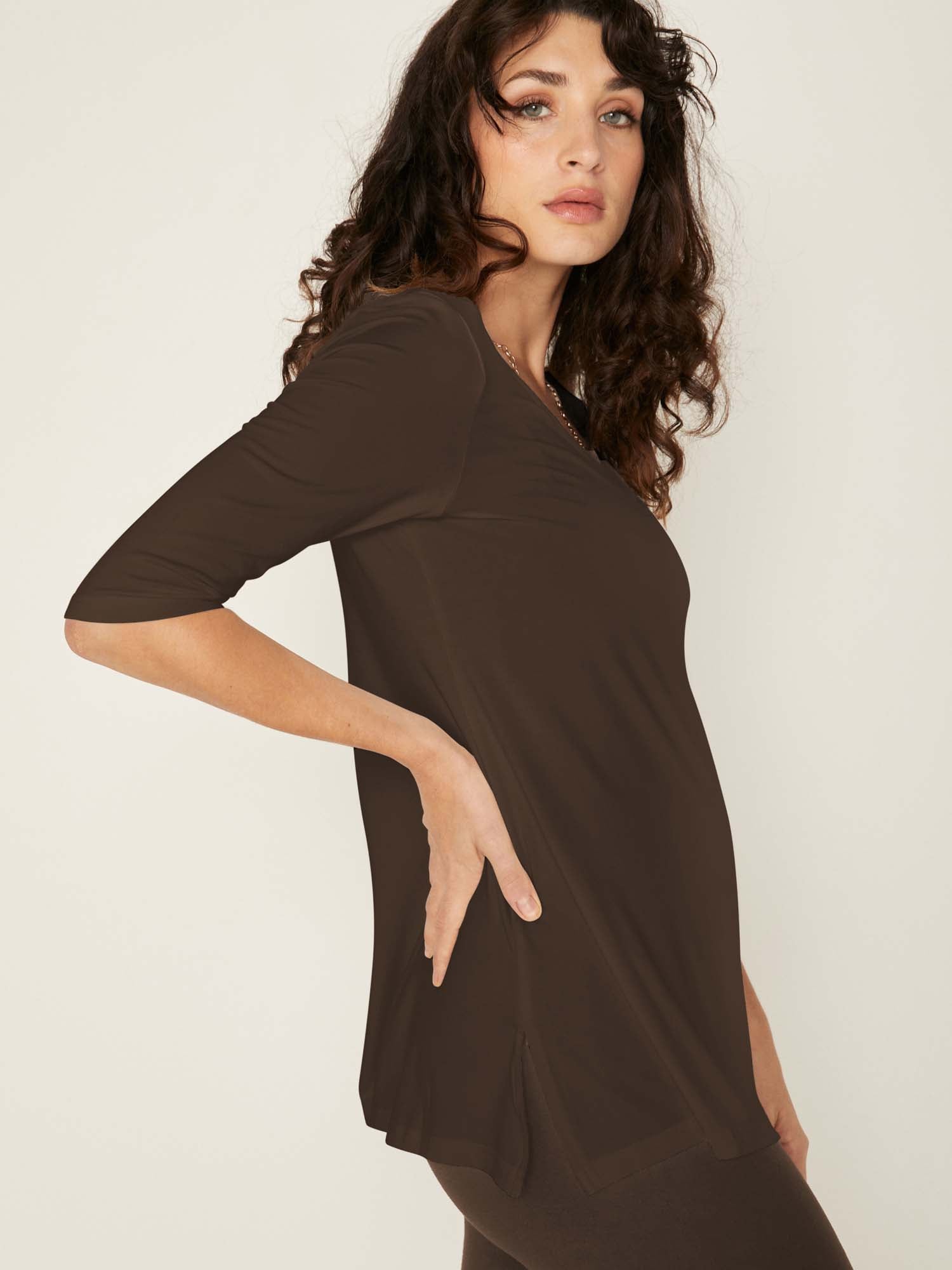 Model wearing a reversible cocoa brown mid sleeve t-shirt with scoop and boat necklines, a-line long line body, women's bamboo clothing