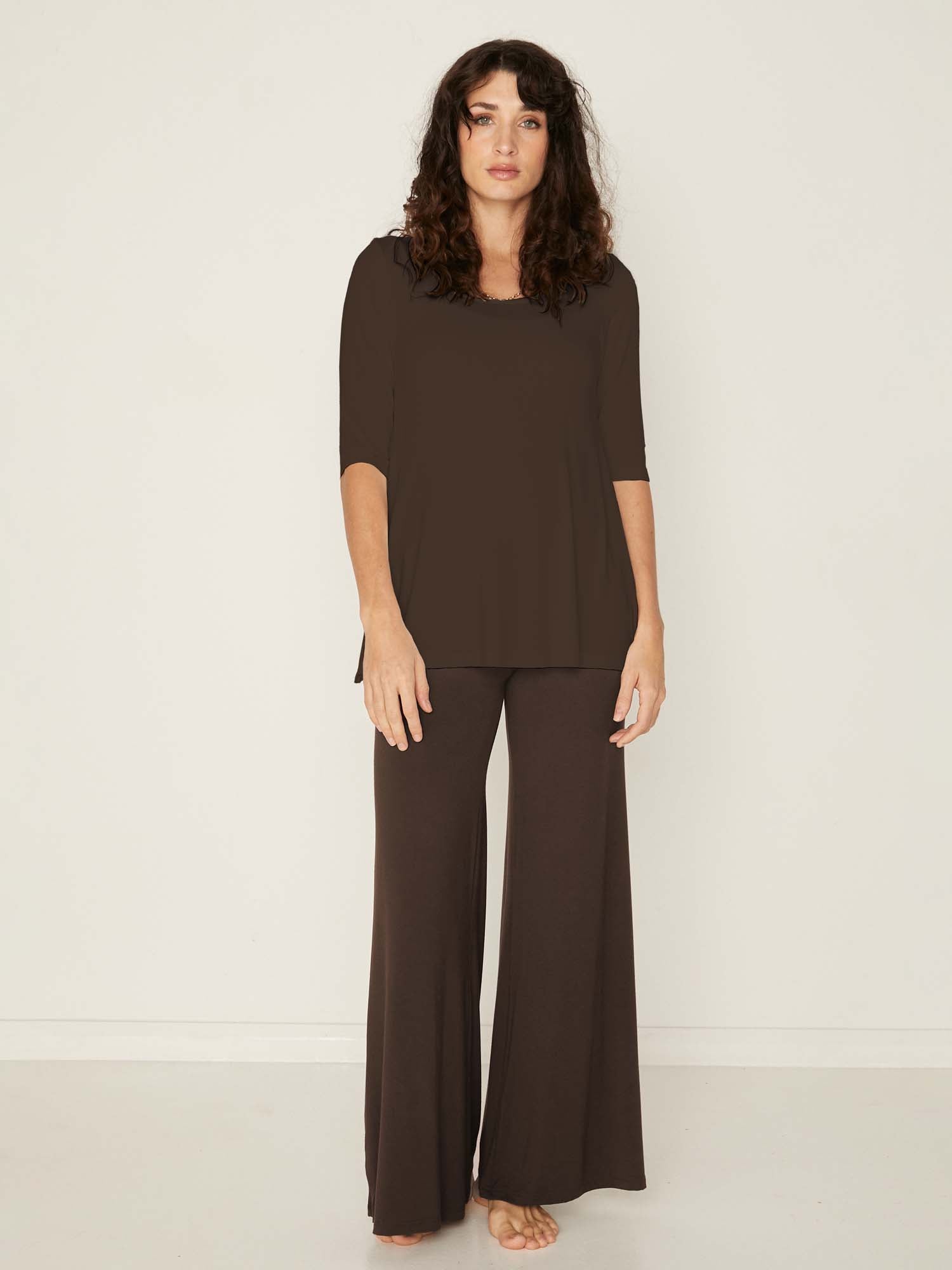 Model wearing a reversible cocoa brown mid sleeve t-shirt with scoop and boat necklines, a-line long line body, women's bamboo clothing
