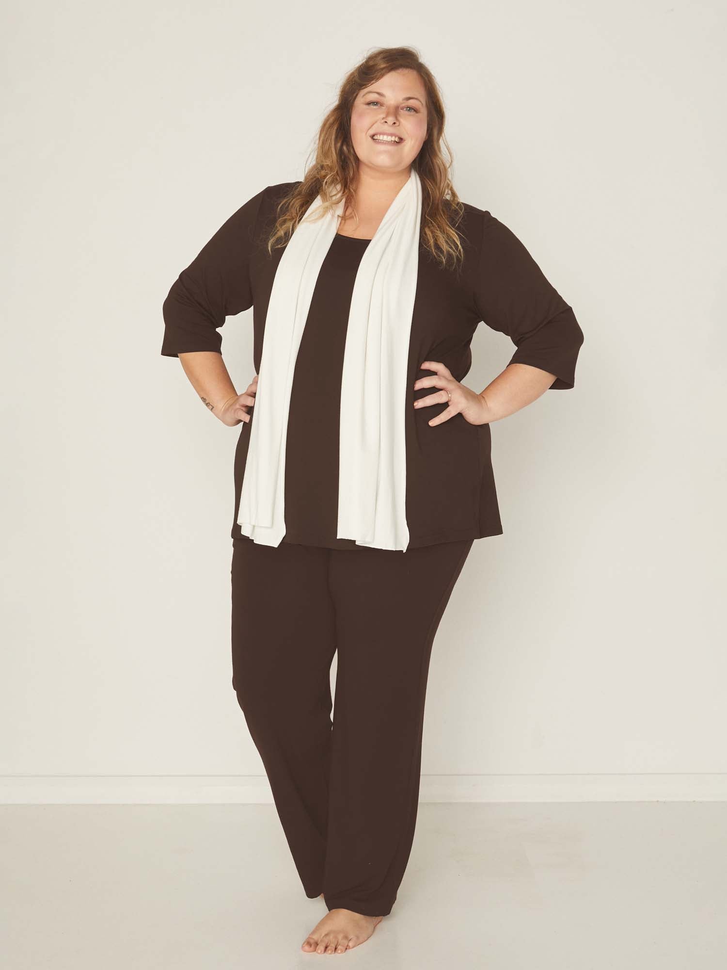 Model wearing a reversible cocoa brown mid sleeve t-shirt with scoop and boat necklines, a-line long line body, women's bamboo clothing