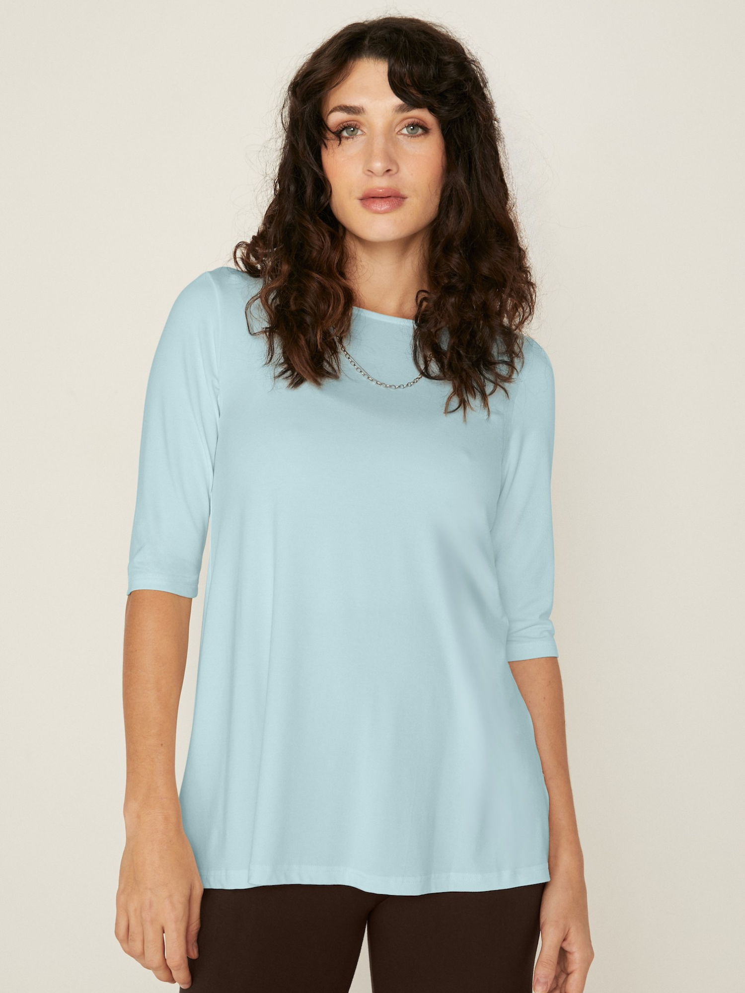 Woman wearing a bamboo light topaz blue mid sleeve t-shirt with a boat neckline on a white background