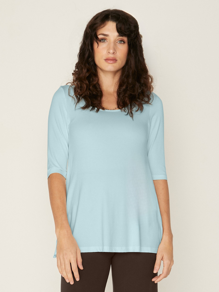 Woman wearing a bamboo light topaz blue mid sleeve t-shirt with a scoop neckline and cocoa brown wide leg palazzo pants on a white background