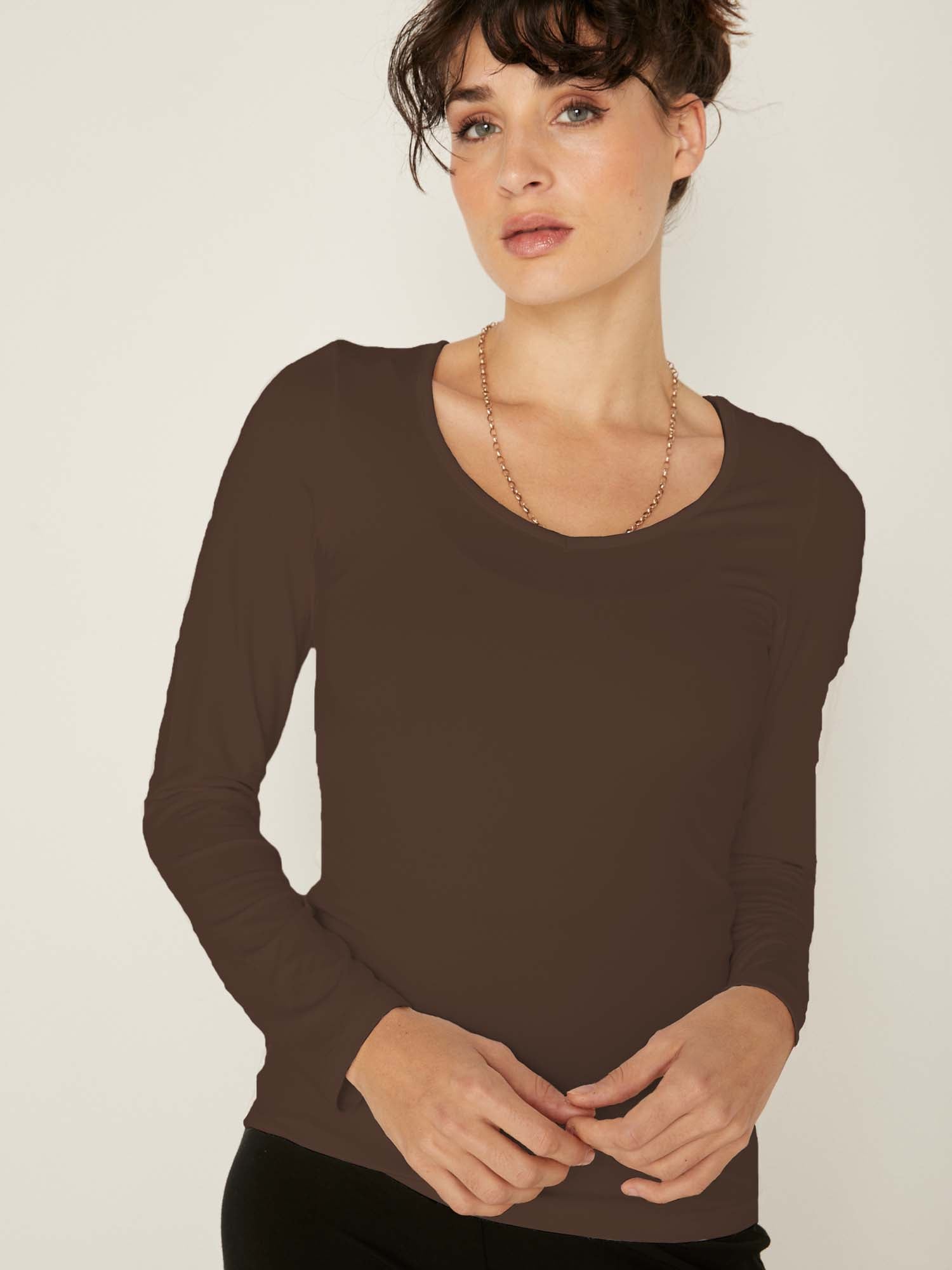 Model wearing a reversible cocoa brown fitted body, long sleeve t-shirt with v and boat necklines, women's bamboo clothing