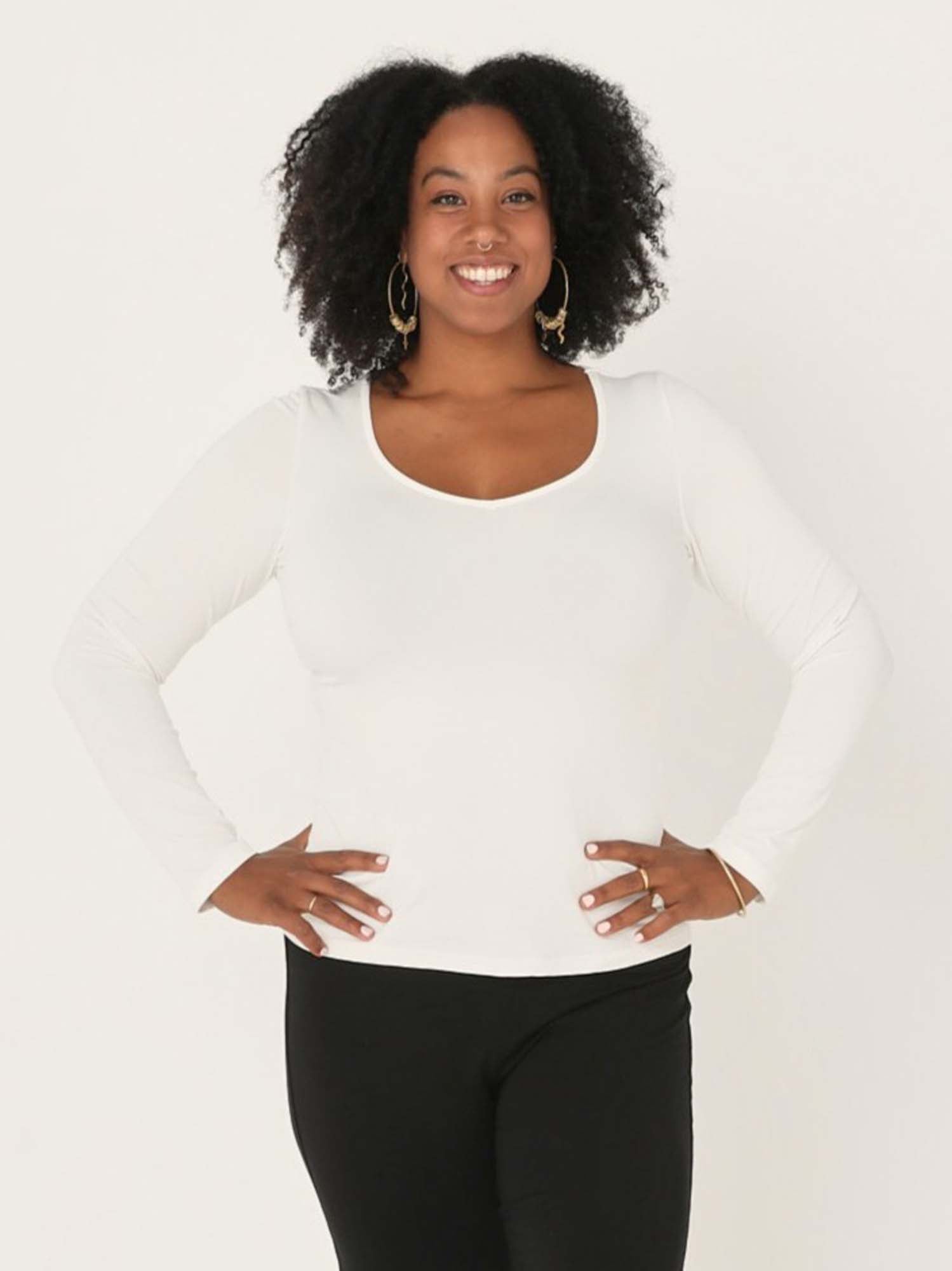 Model wearing a reversible cream fitted body, long sleeve t-shirt with v and boat necklines, women's bamboo clothing